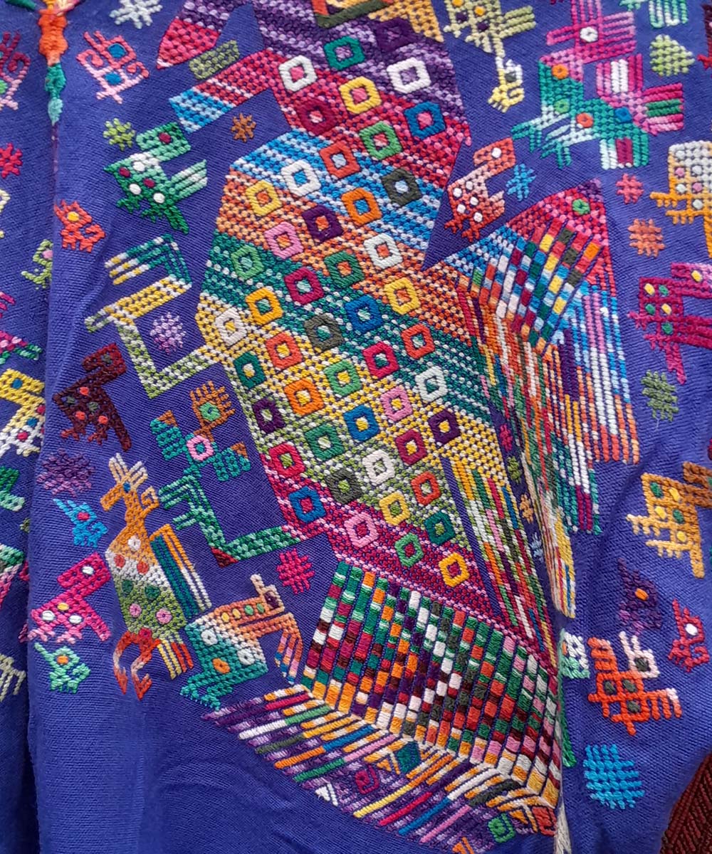 Bright blue Nahuala huipil with quetzales