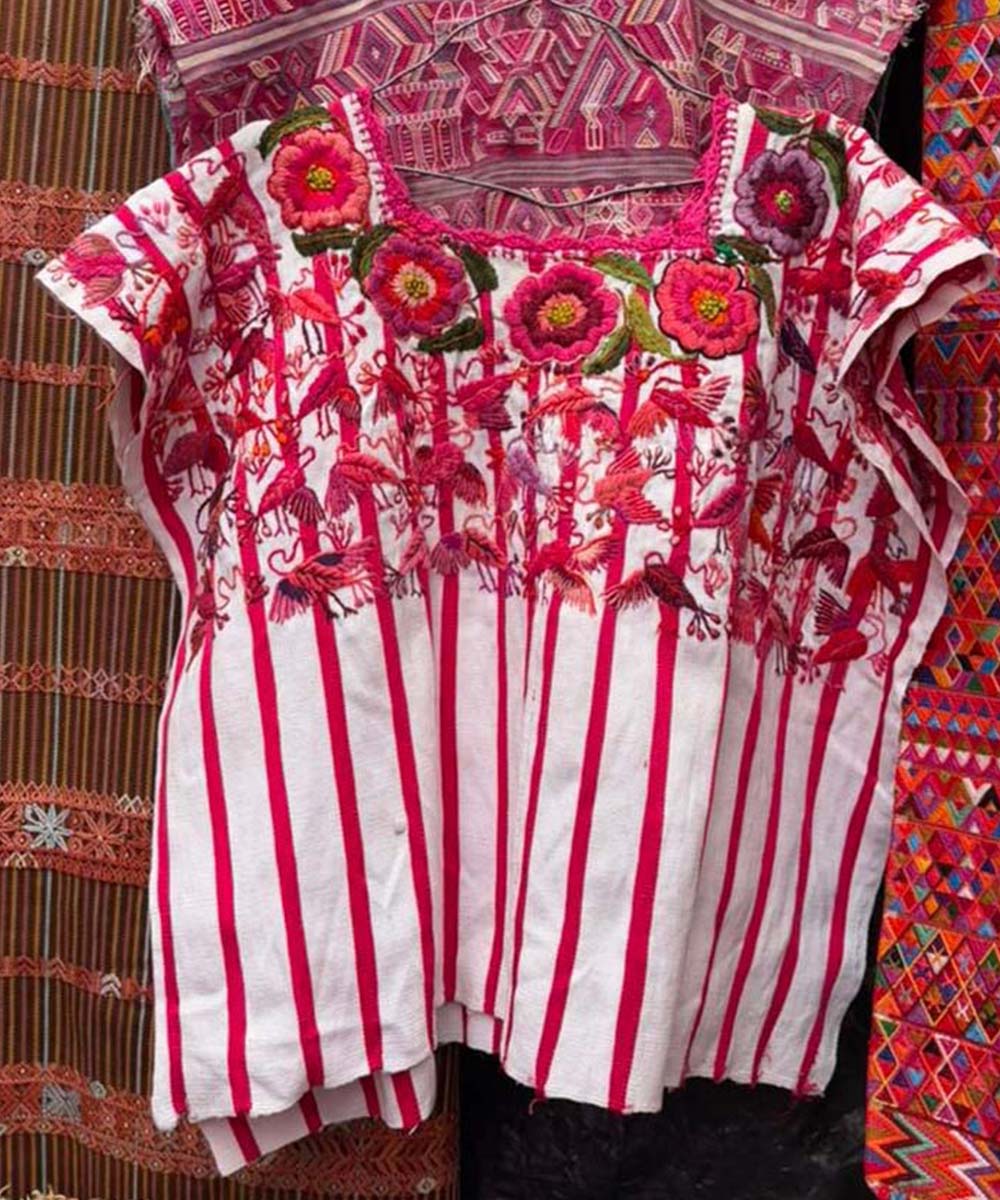 Red and white Santiago huipil with birds and flowers