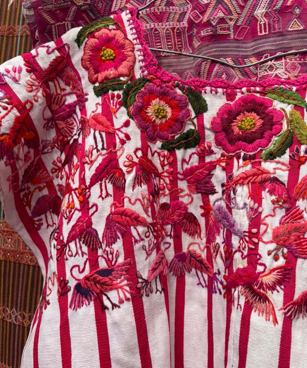 Red and white Santiago huipil with birds and flowers