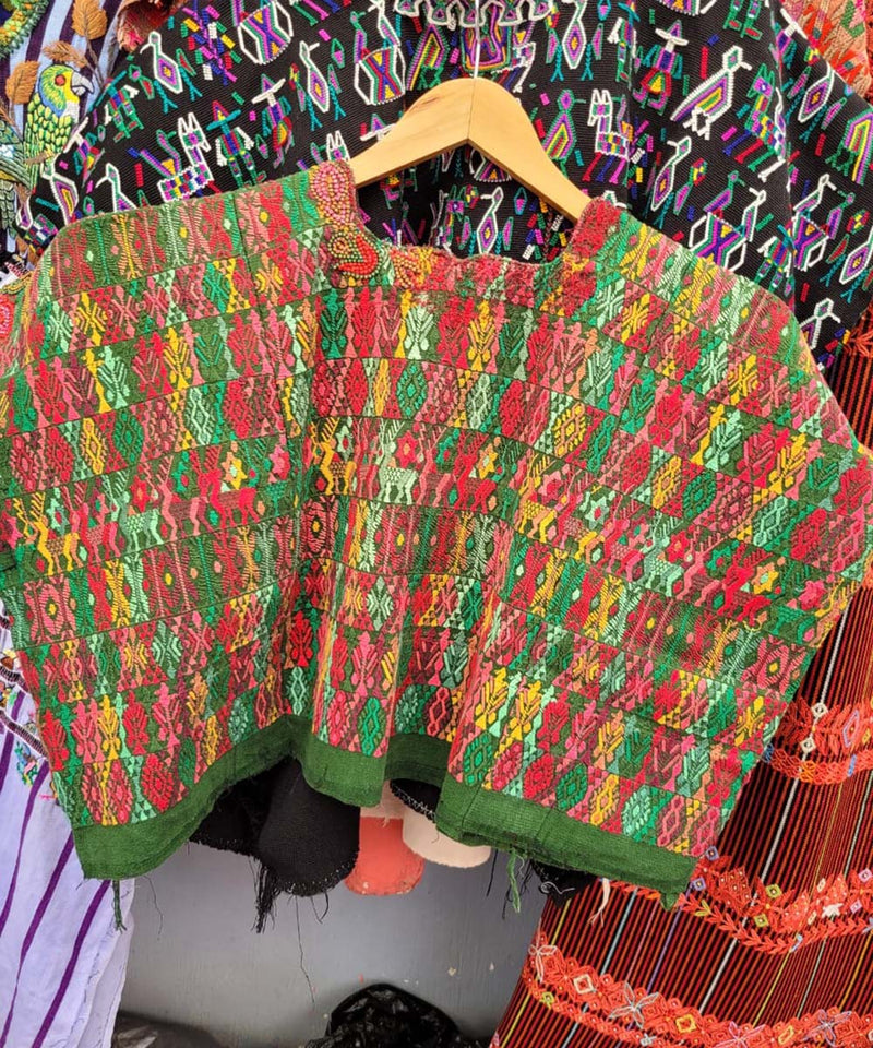 Colorful on green Coban huipil