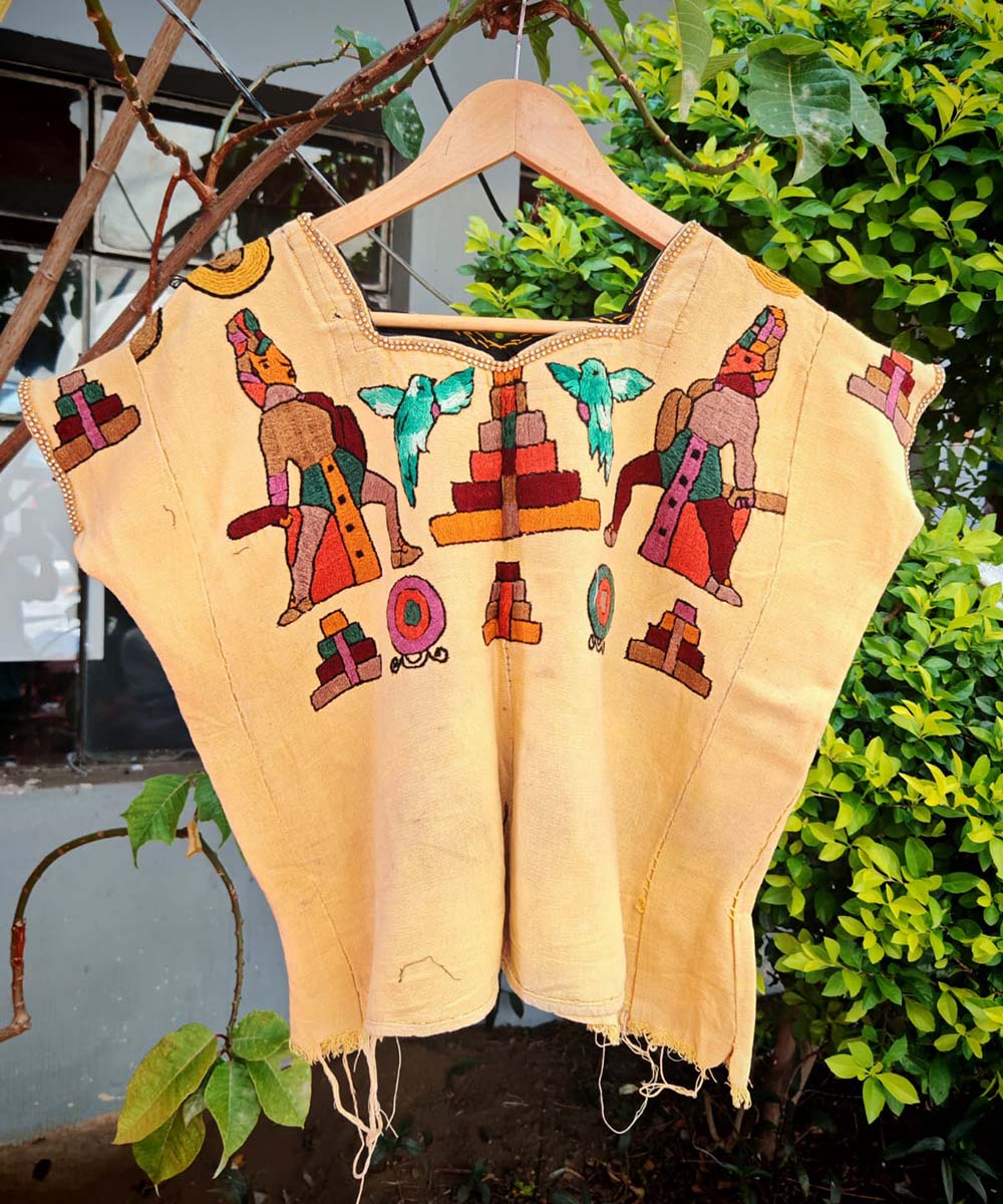 Yellow huipil with ceremonial Mayan men