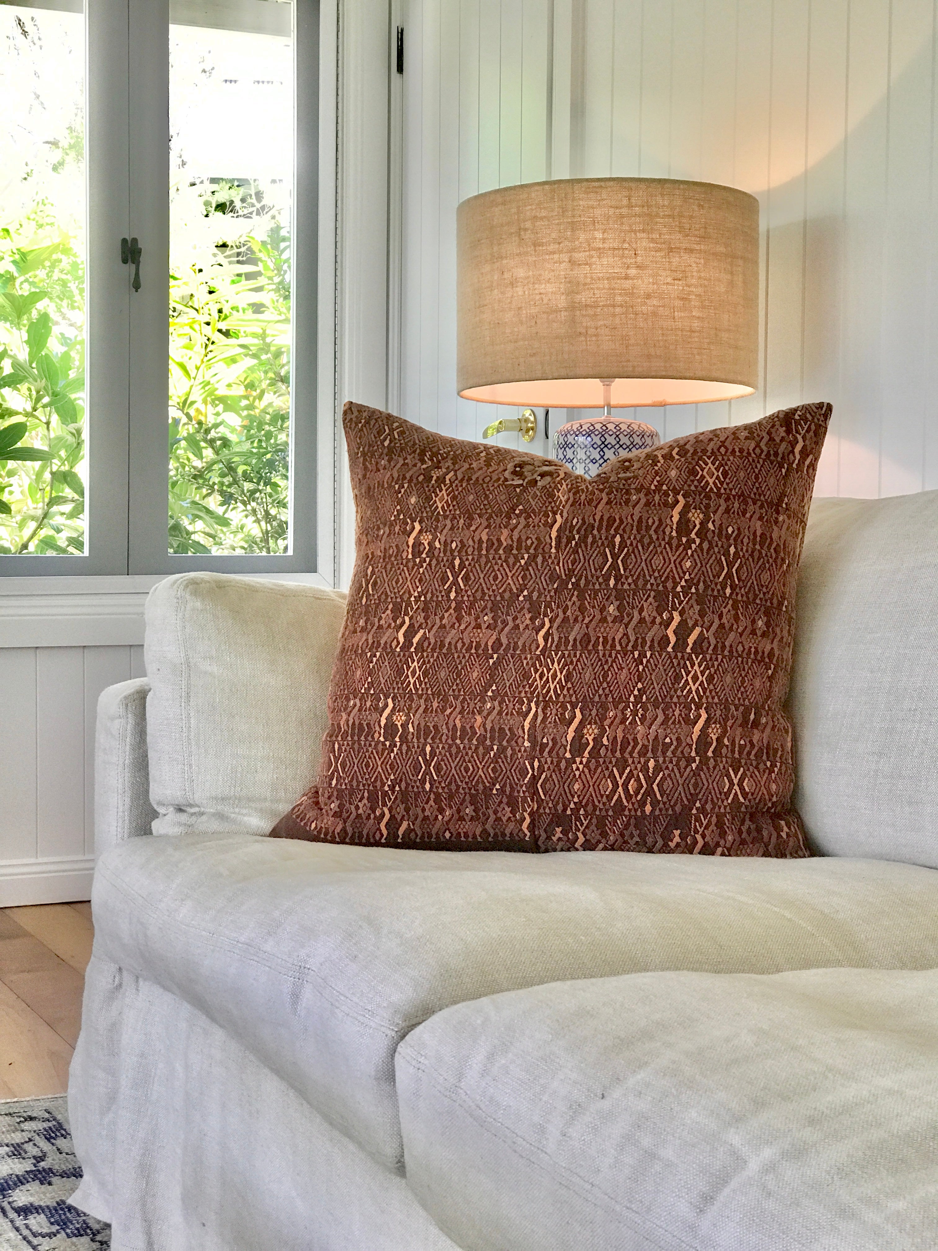 Embroidered textile cushions made from a Guatemalan huipil and corte.