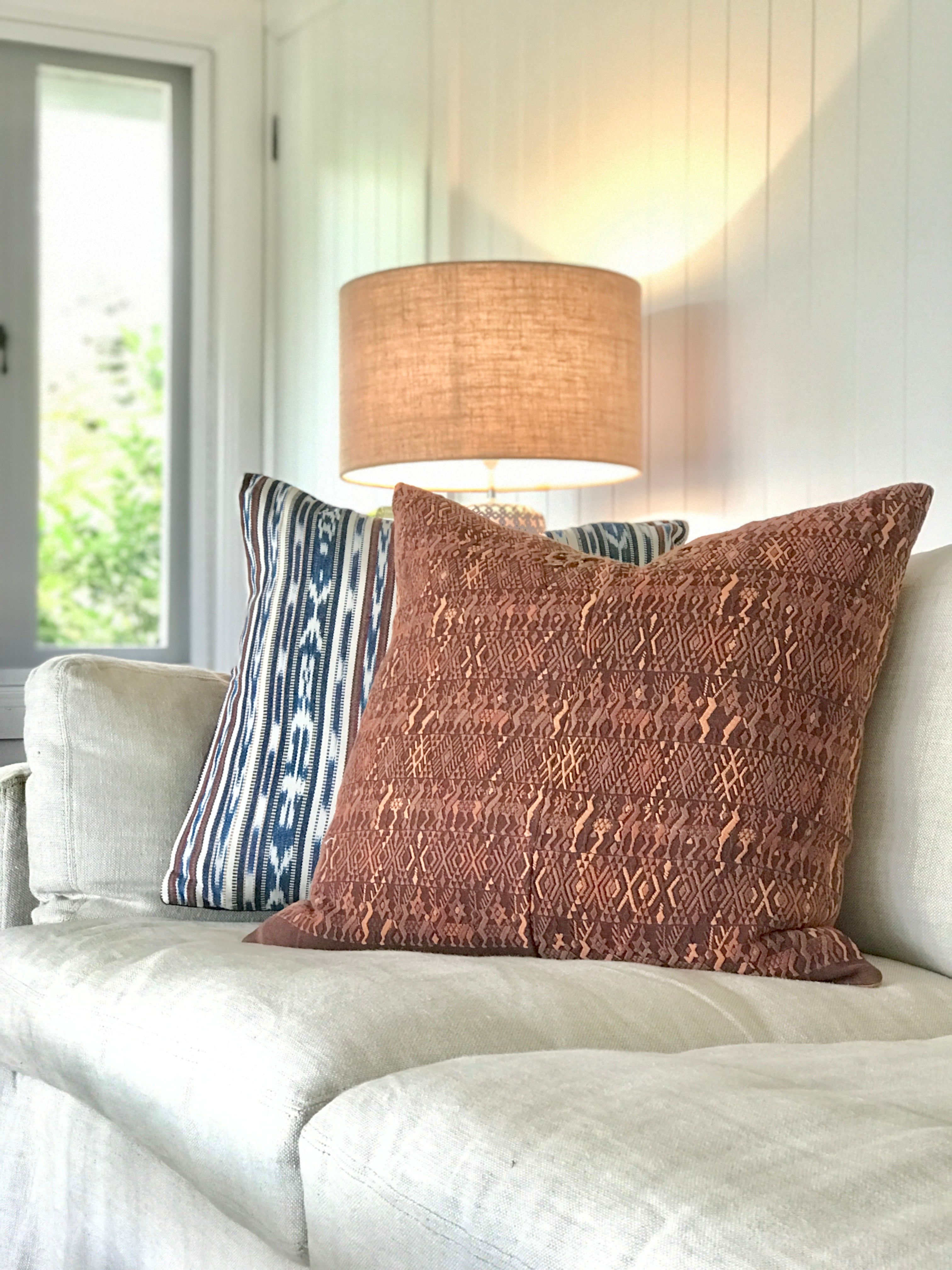 Embroidered textile cushions made from a Guatemalan huipil and corte.