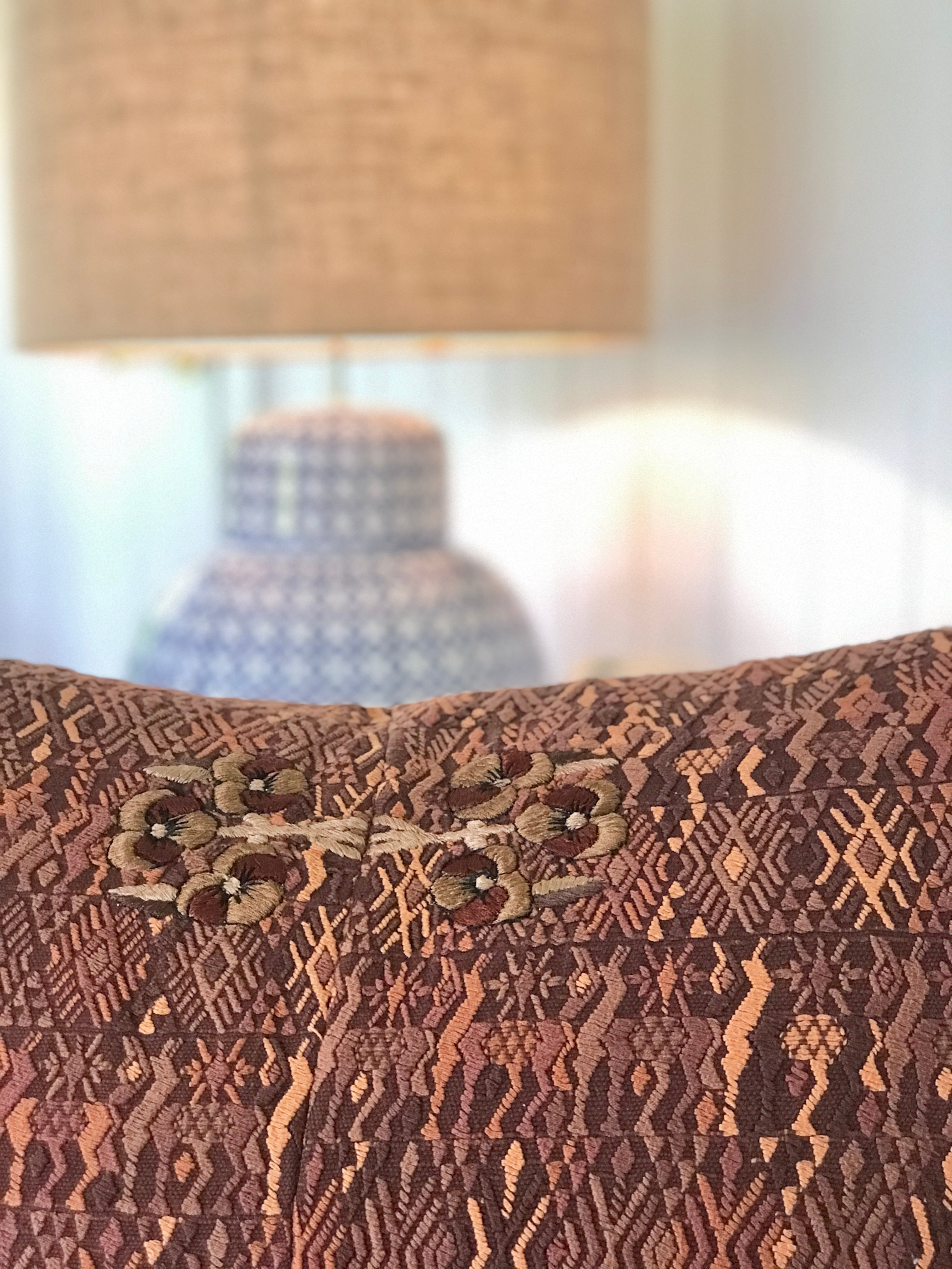 Embroidered textile cushions made from a Guatemalan huipil and corte.
