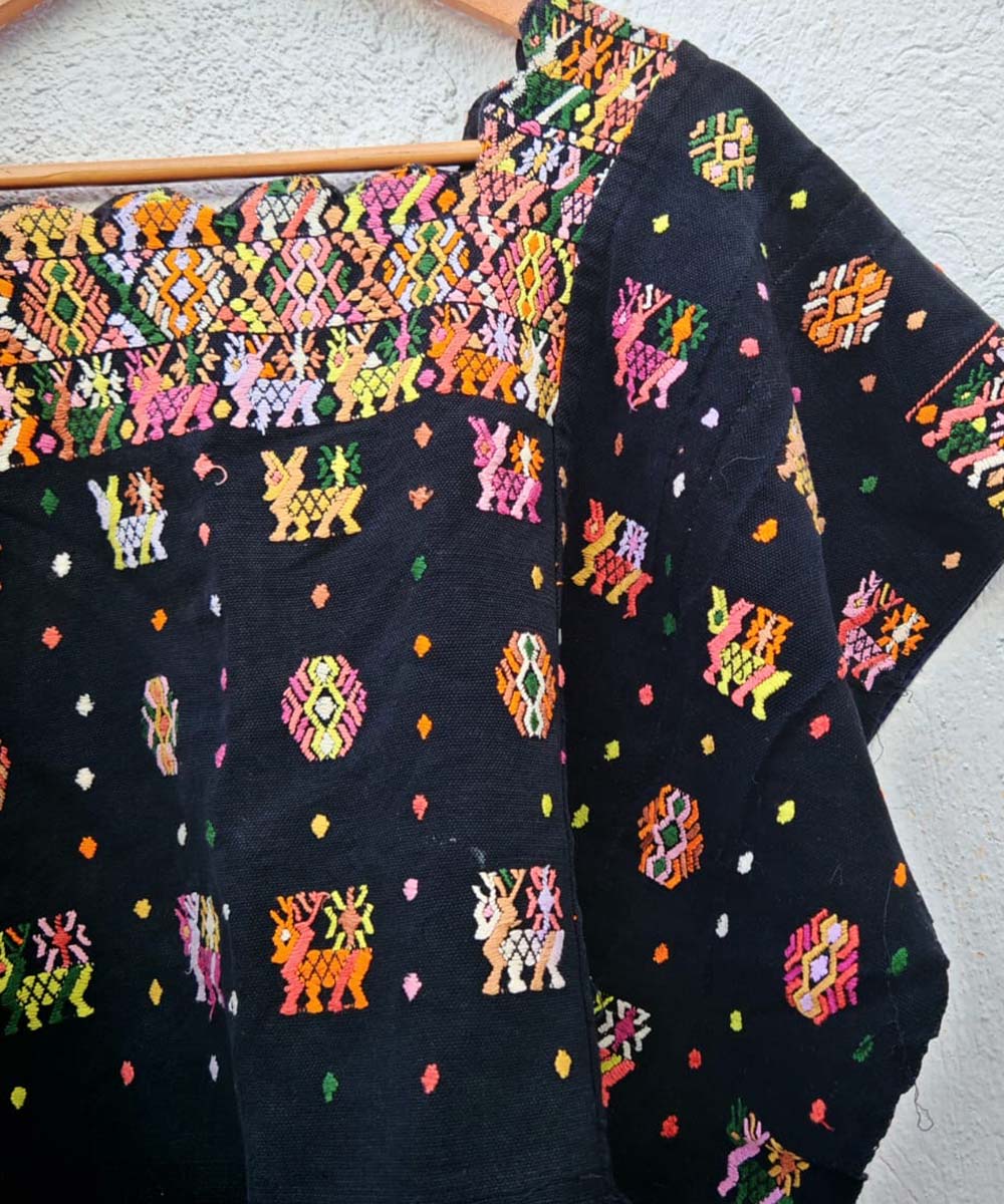 Black Coban huipil with colorful motifs