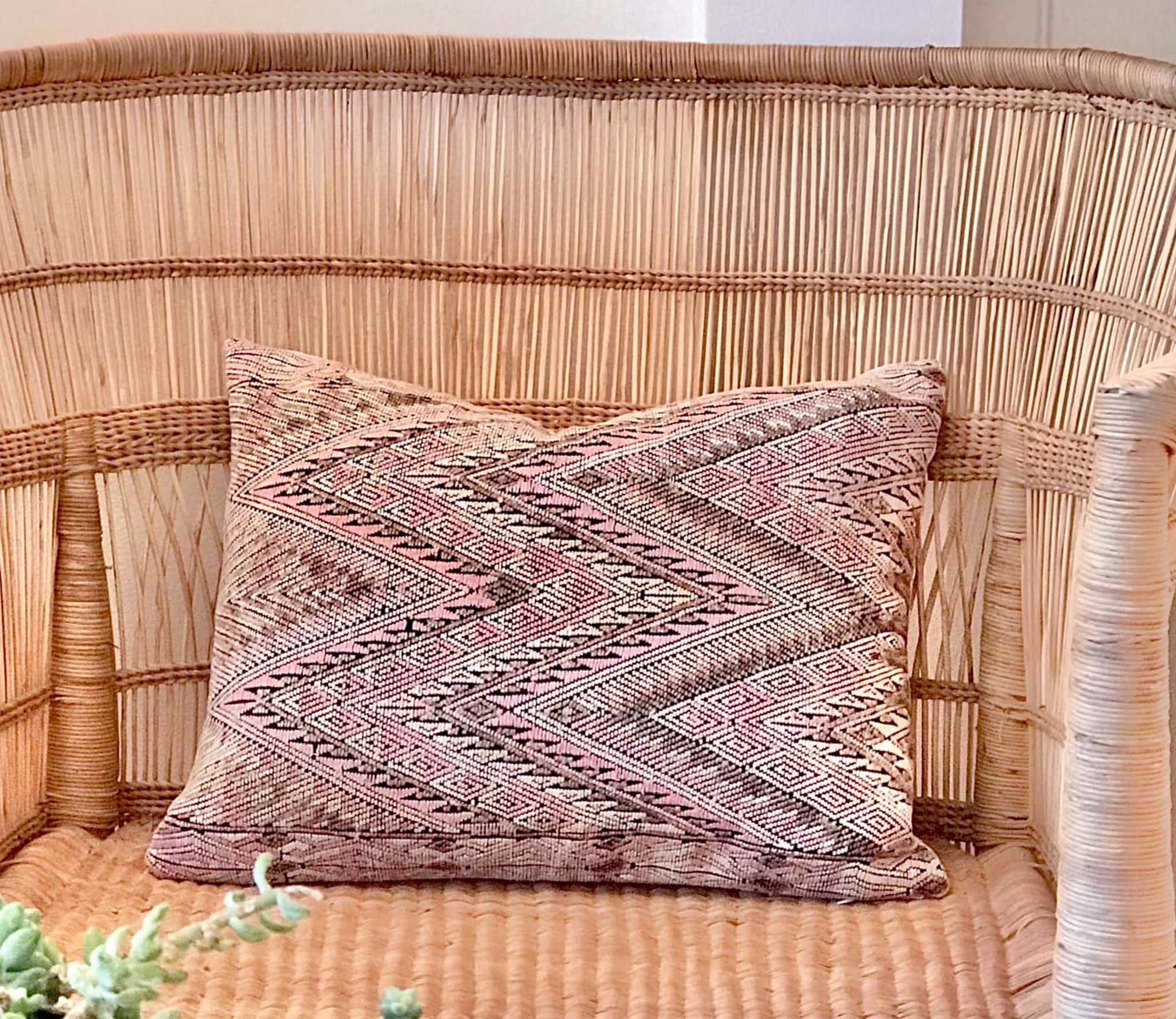 Guatemalan embroidered huipil pillow. Geometric chevron pattern in a pale pink palette.