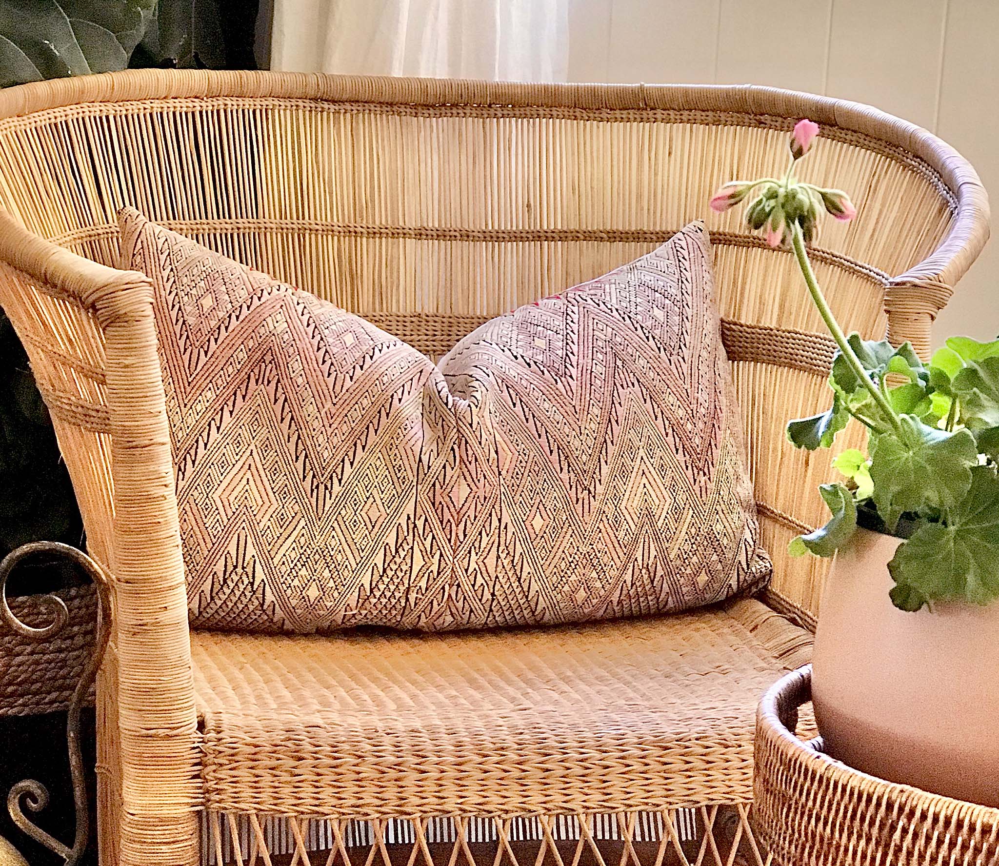 Guatemalan embroidered huipil pillow. Geometric chevron pattern in a pale pink palette.