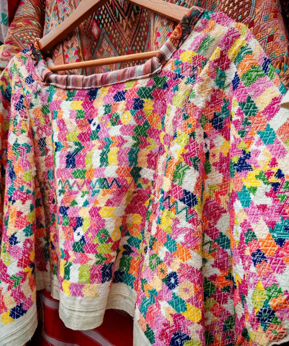 Colorful on white Coban huipil