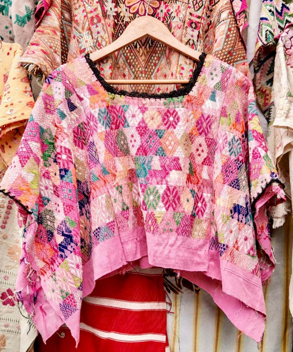 Colorful pink Coban huipil with black neckline