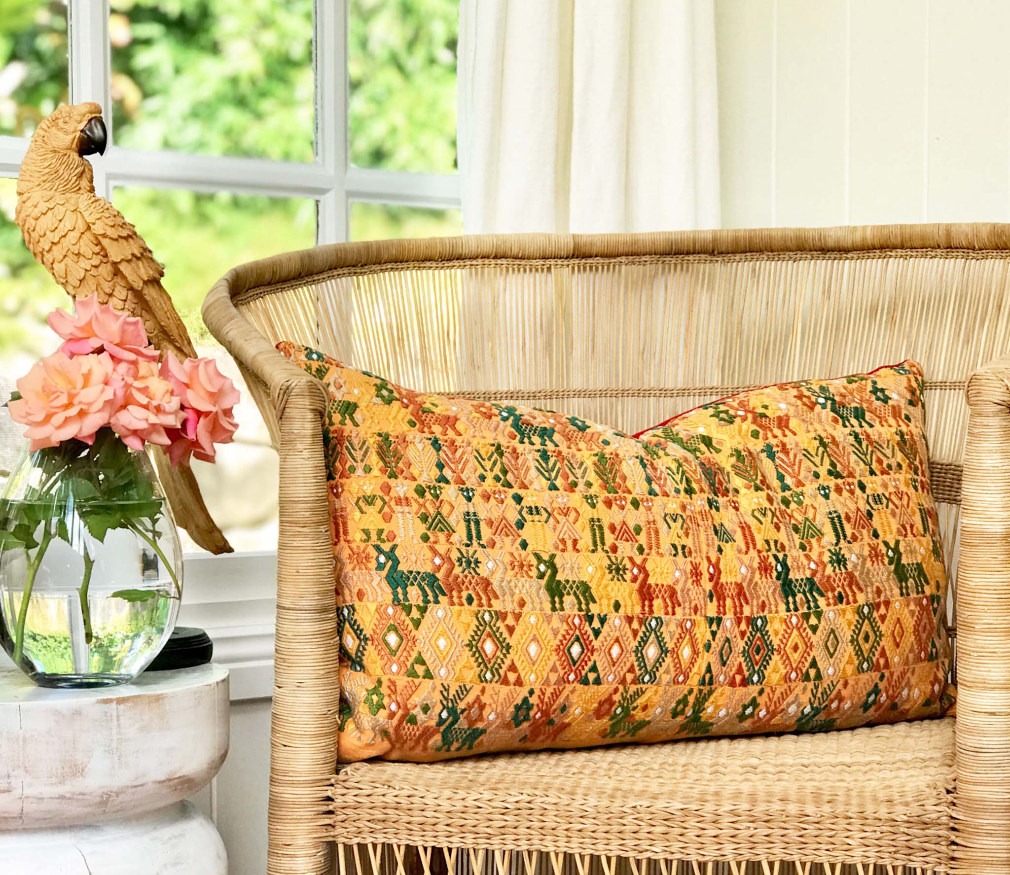 Embroidered textile cushions made from a Guatemalan huipil and corte.