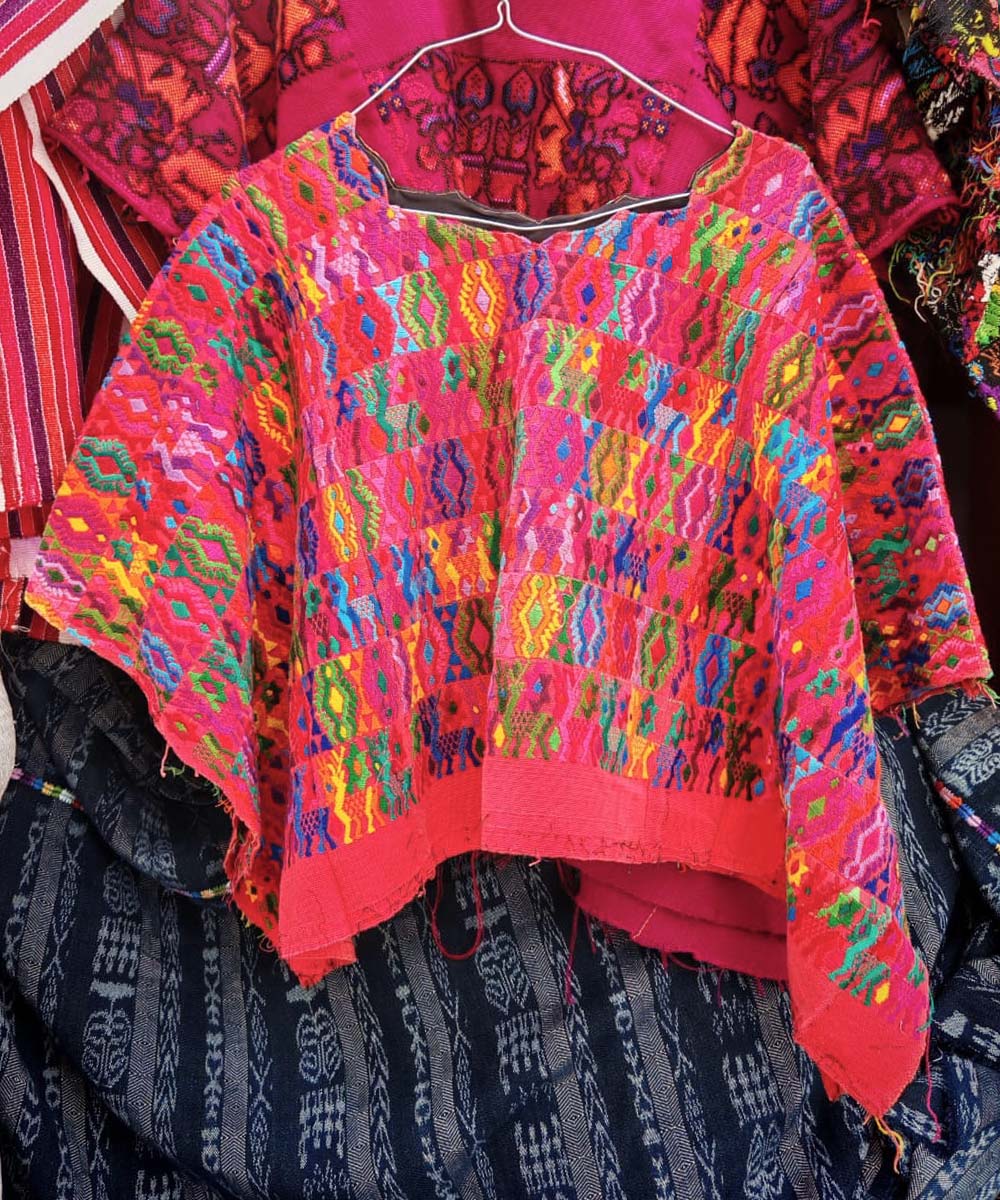 Colourful on red Coban huipil