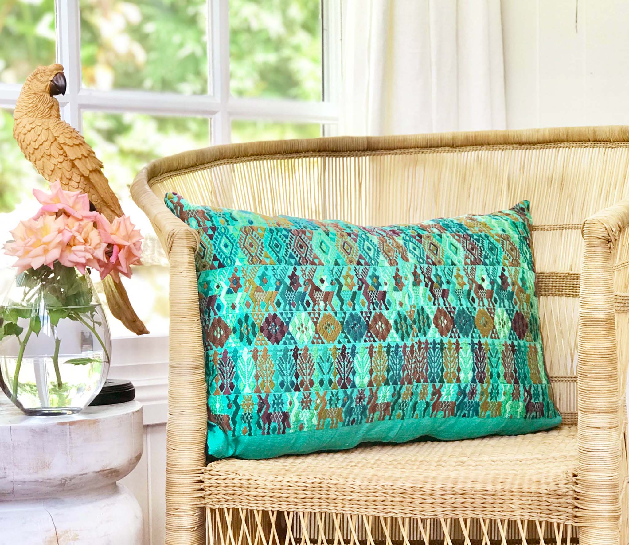 Embroidered textile cushions made from a Guatemalan huipil and corte.