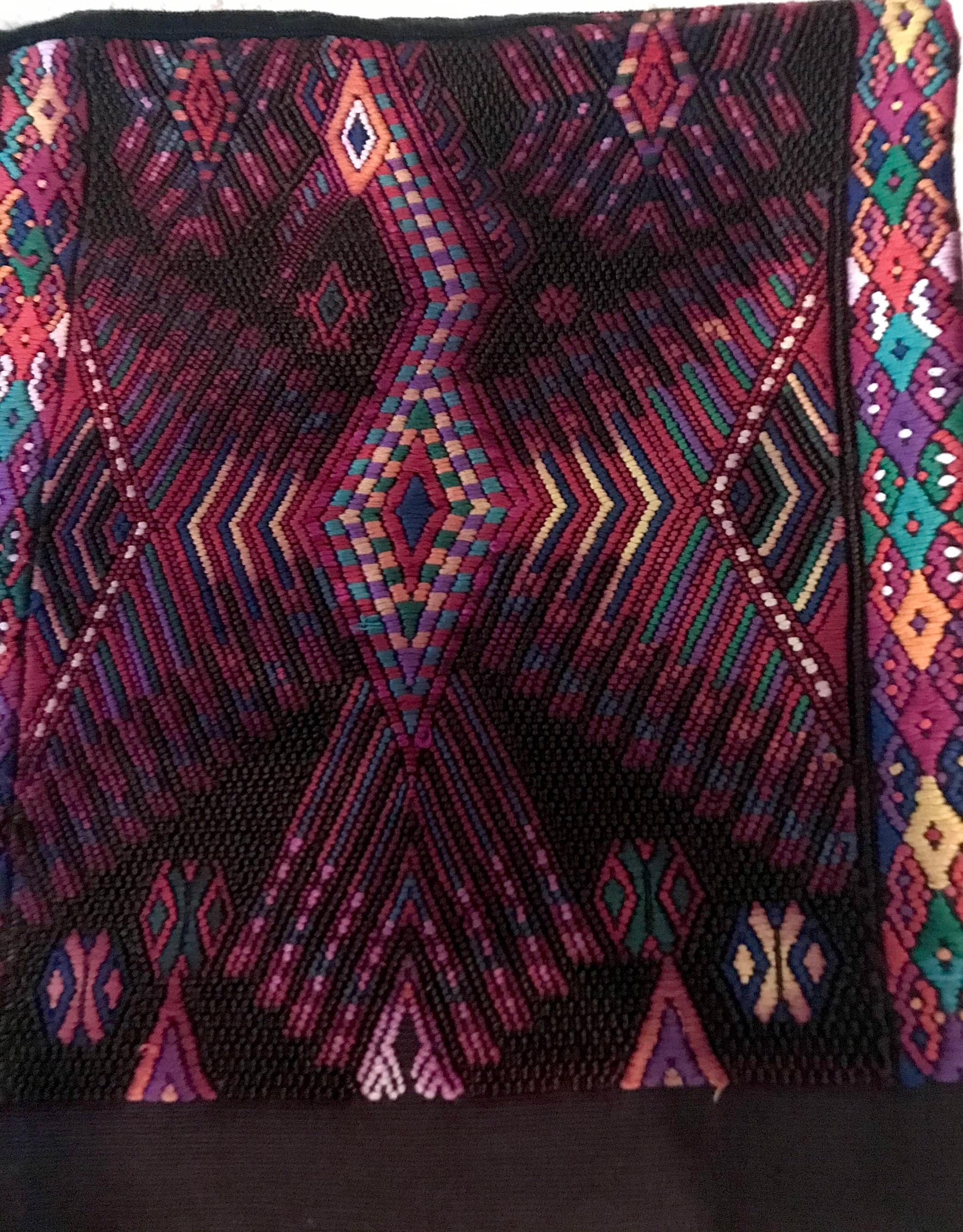 Guatemalan huipil pillow. A darkly exotic vintage textile with a stylised rising phoenix bird design.