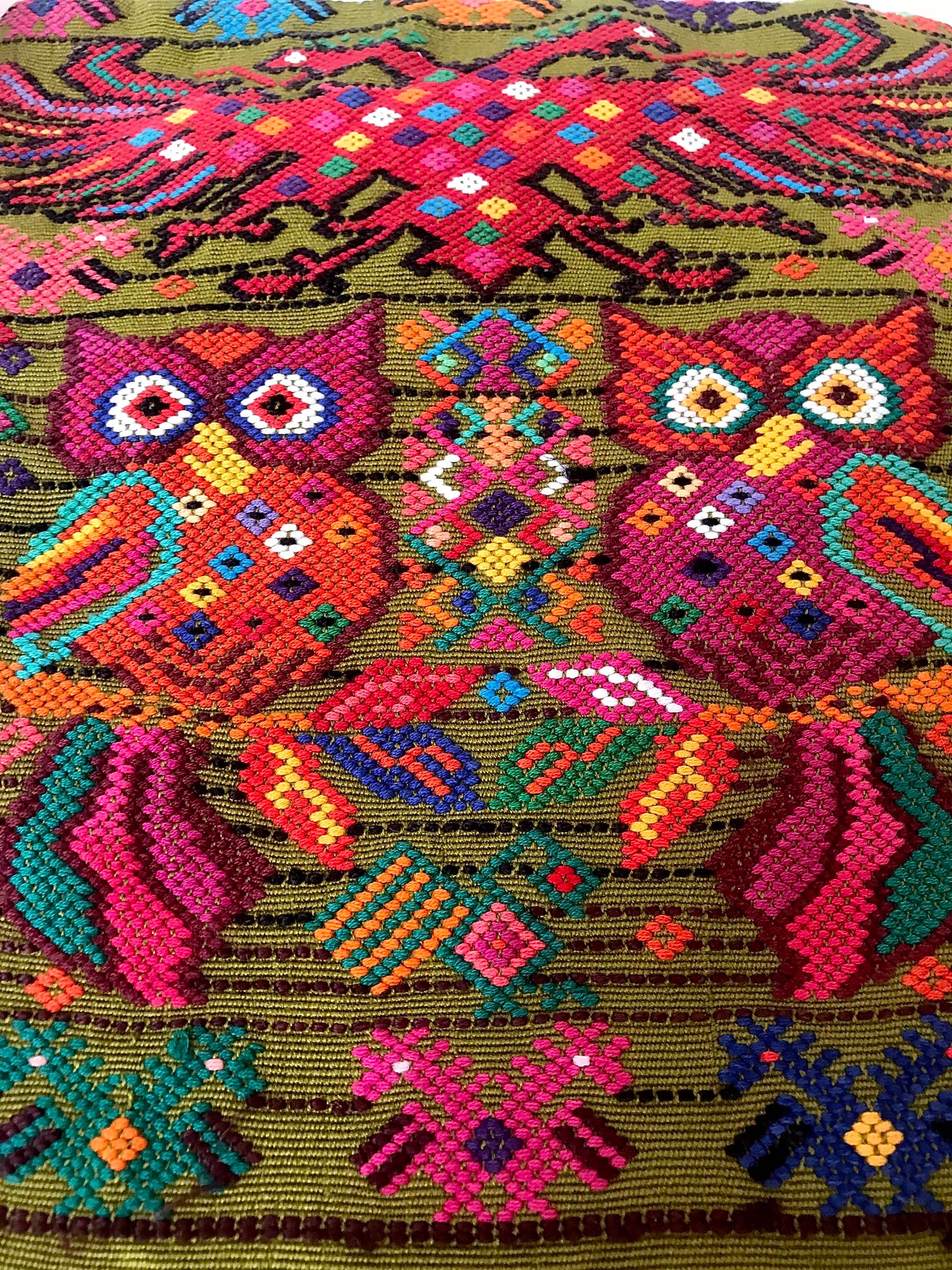 Guatemalan embroidered huipil pillow. Startled owls in a whimsical setting on avocado green cotton