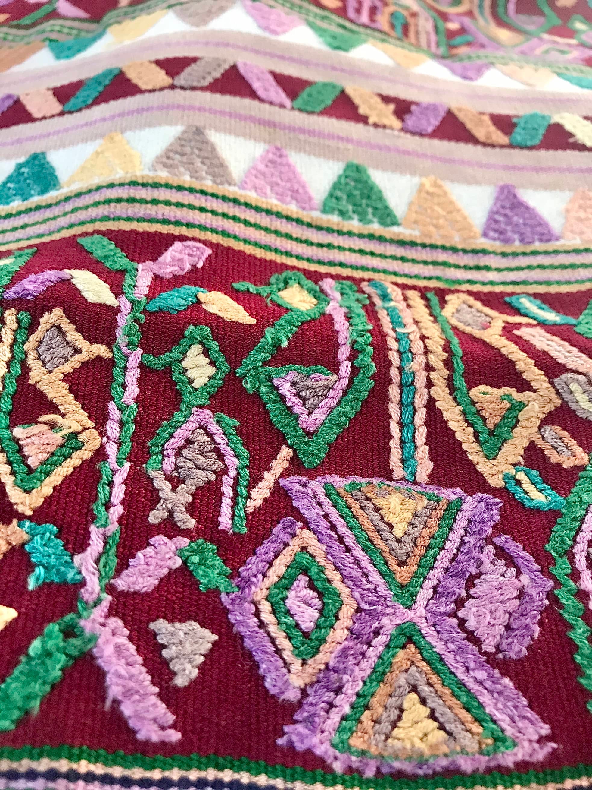 Guatemalan embroidered huipil pillow. Hieroglyphic figures in rows create a strong tribal vibe.