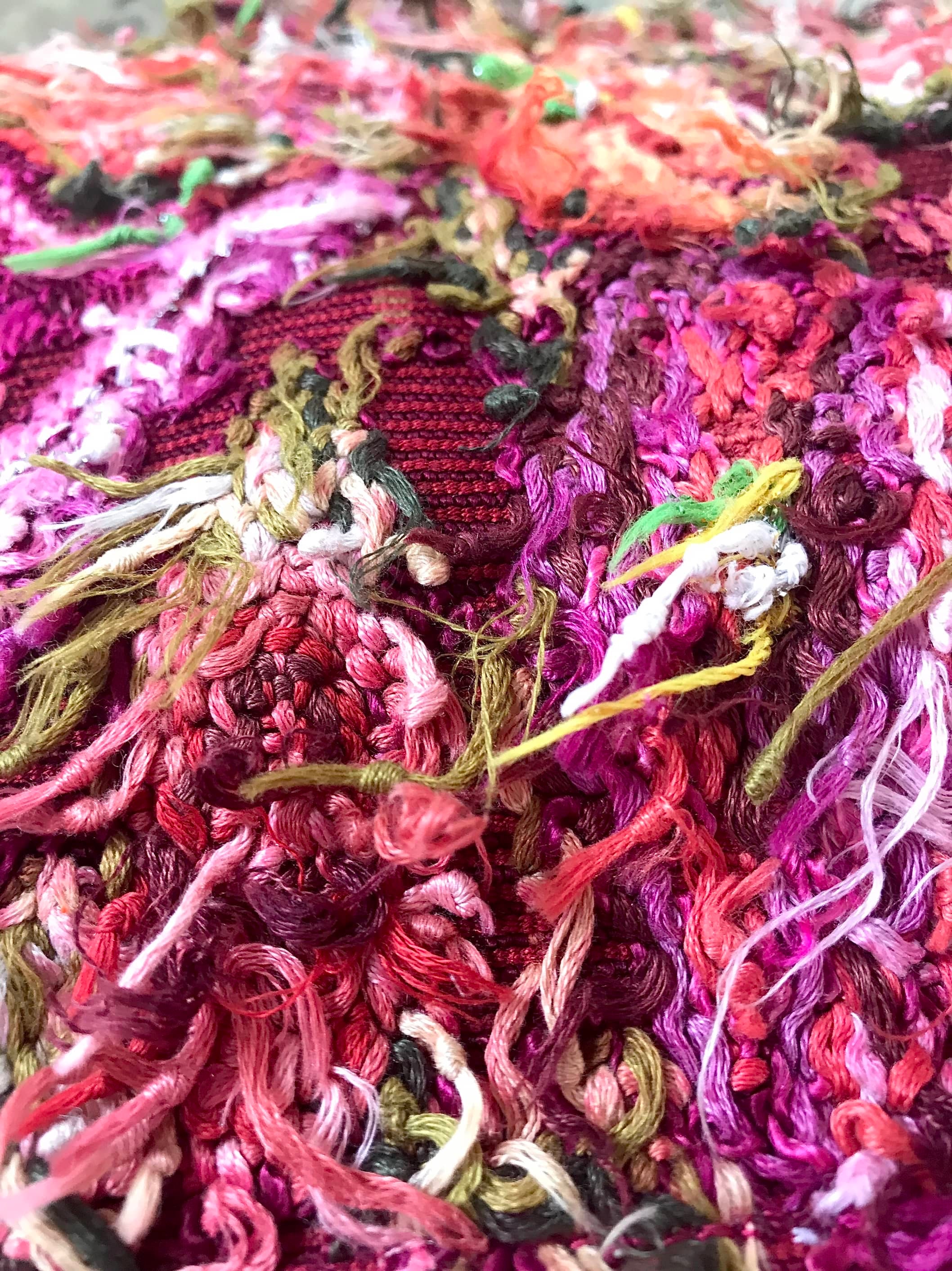 Guatemalan embroidered huipil pillow. Maximilist design of flowers and peacocks in rich burgundy.