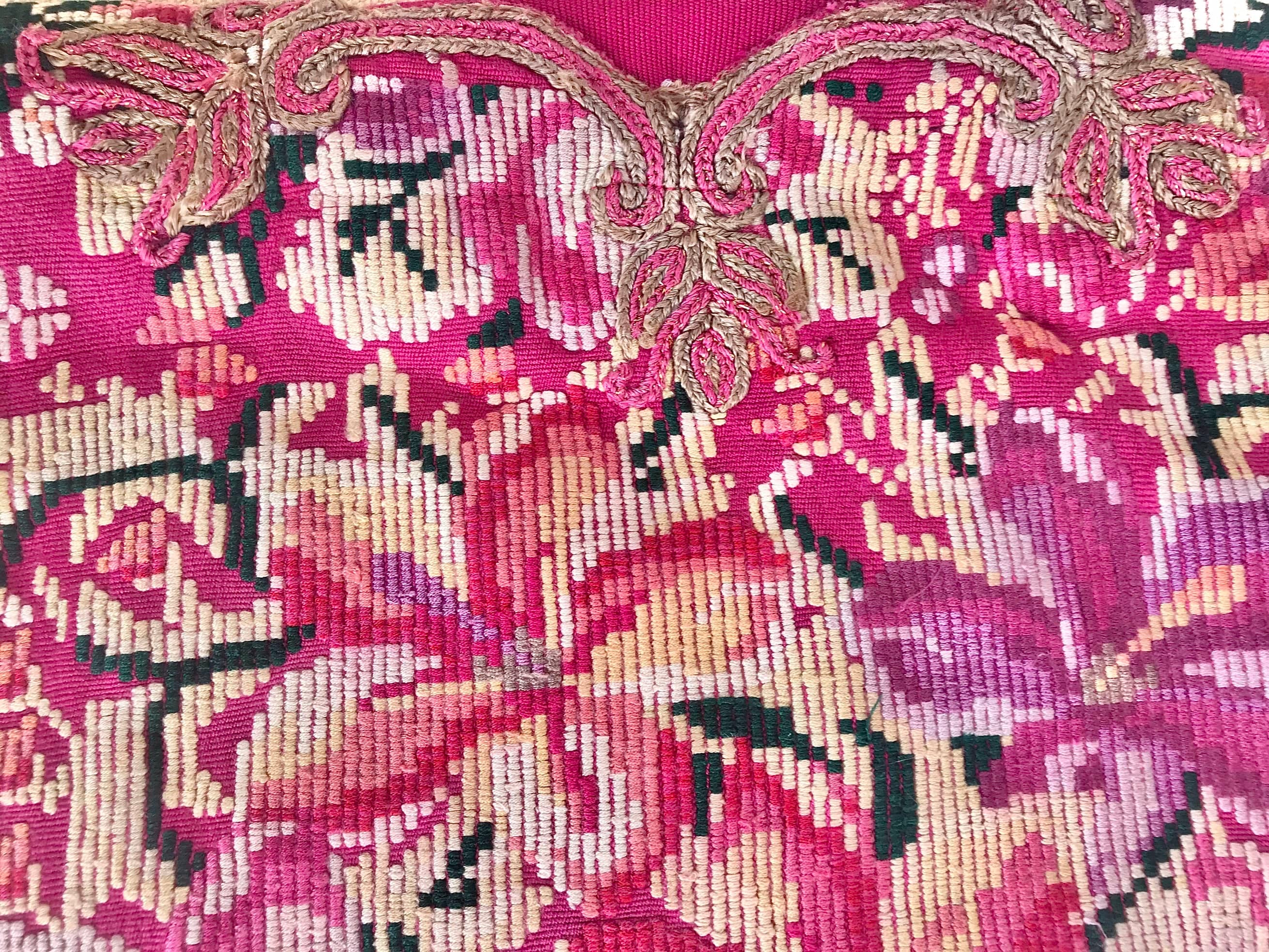 Guatemalan embroidered huipil pillow. A fuchsia vintage textile with an abstract floral design.