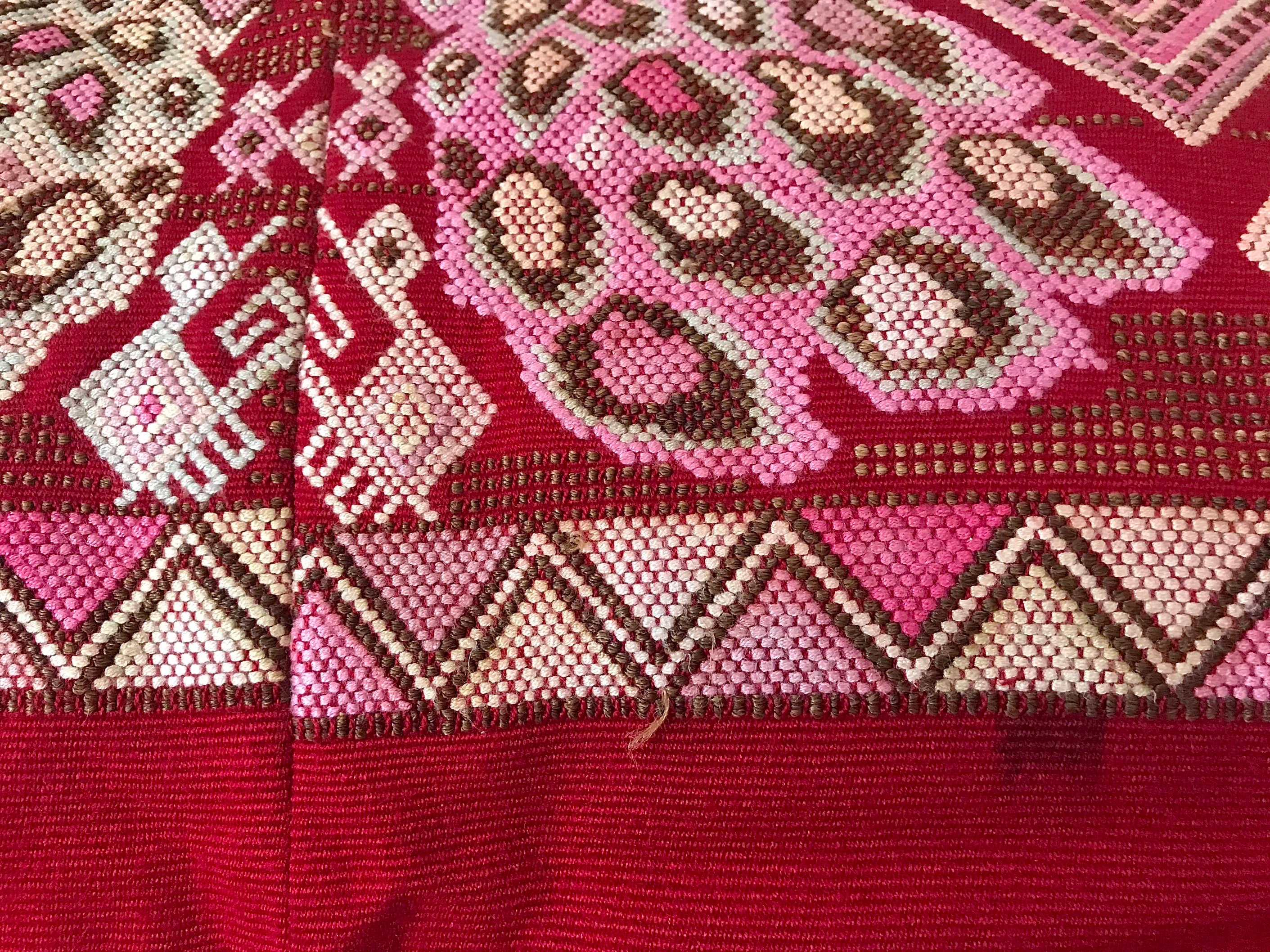 Guatemalan huipil pillow. A vintage textile with a red peacock bird design.