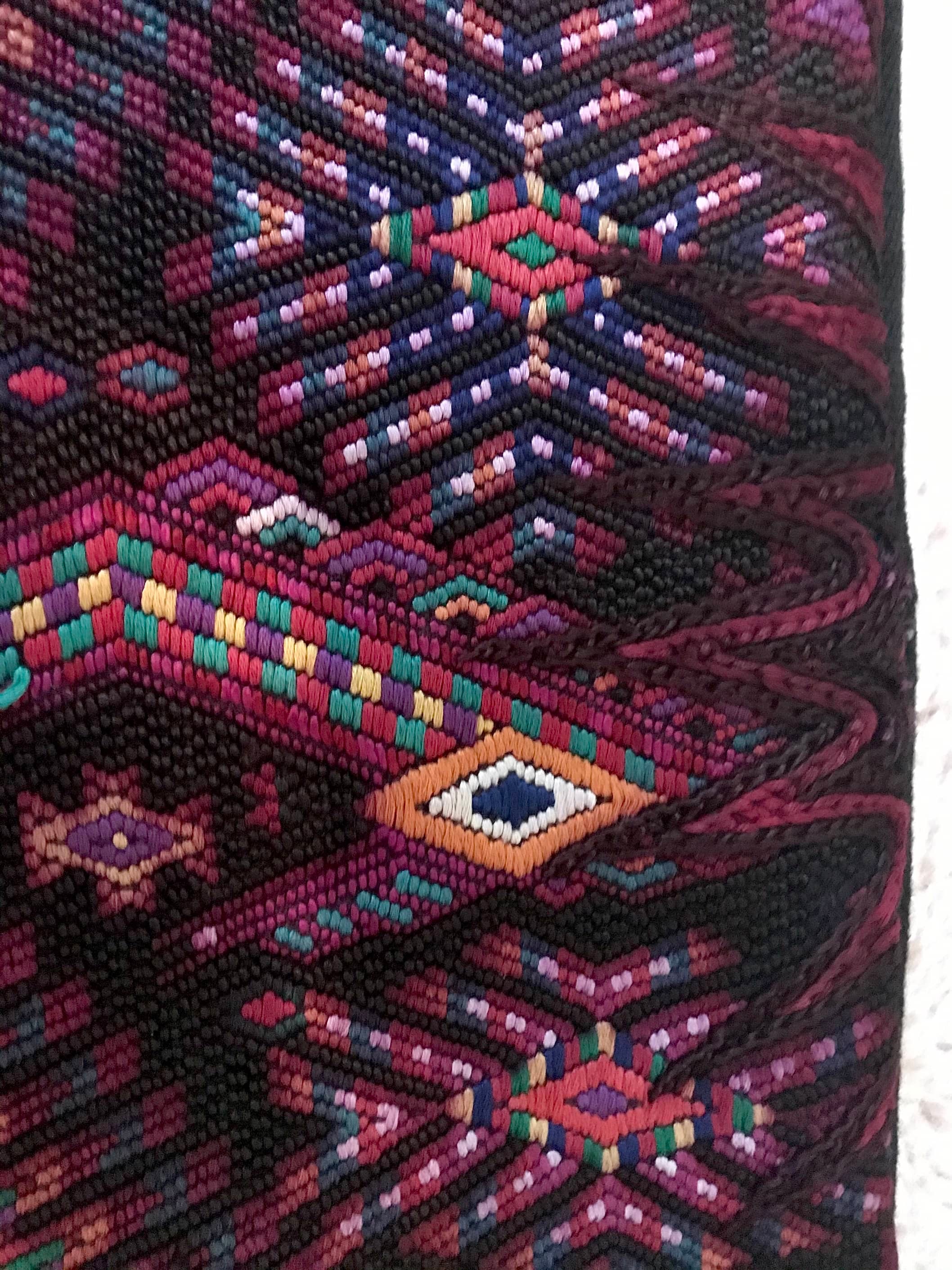 Guatemalan huipil pillow. A darkly exotic vintage textile with a stylised rising phoenix bird design.