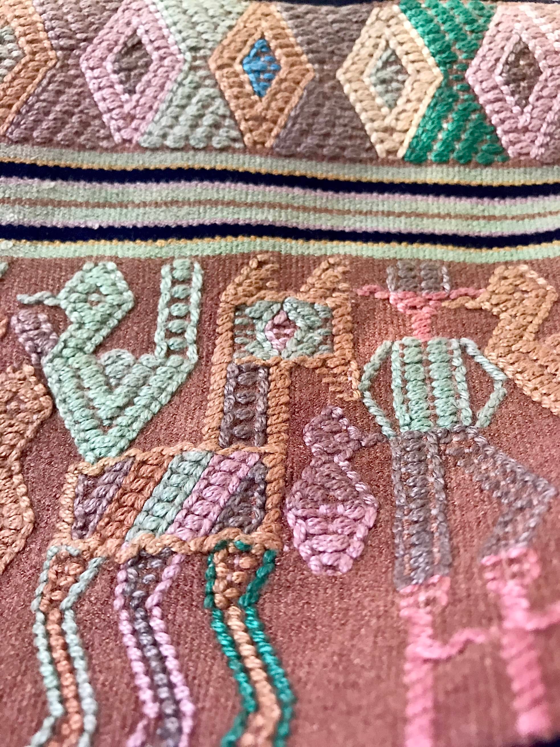 A Pair of Guatemalan Huipil Textile Pillows, vintage, hand embroidered striped tribal hieroglyphic design in aged coral