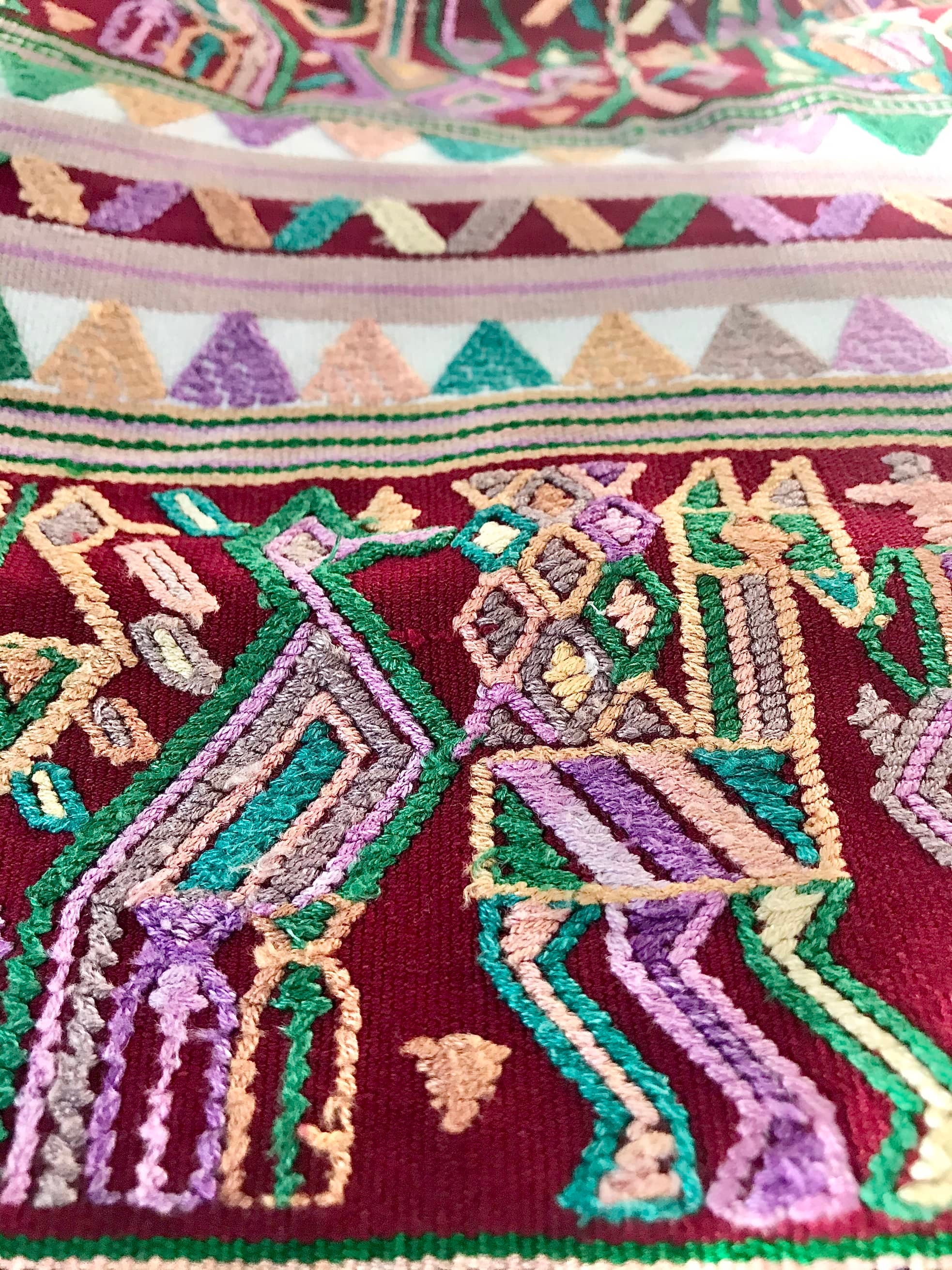 Guatemalan embroidered huipil pillow. Hieroglyphic figures in rows create a strong tribal vibe.