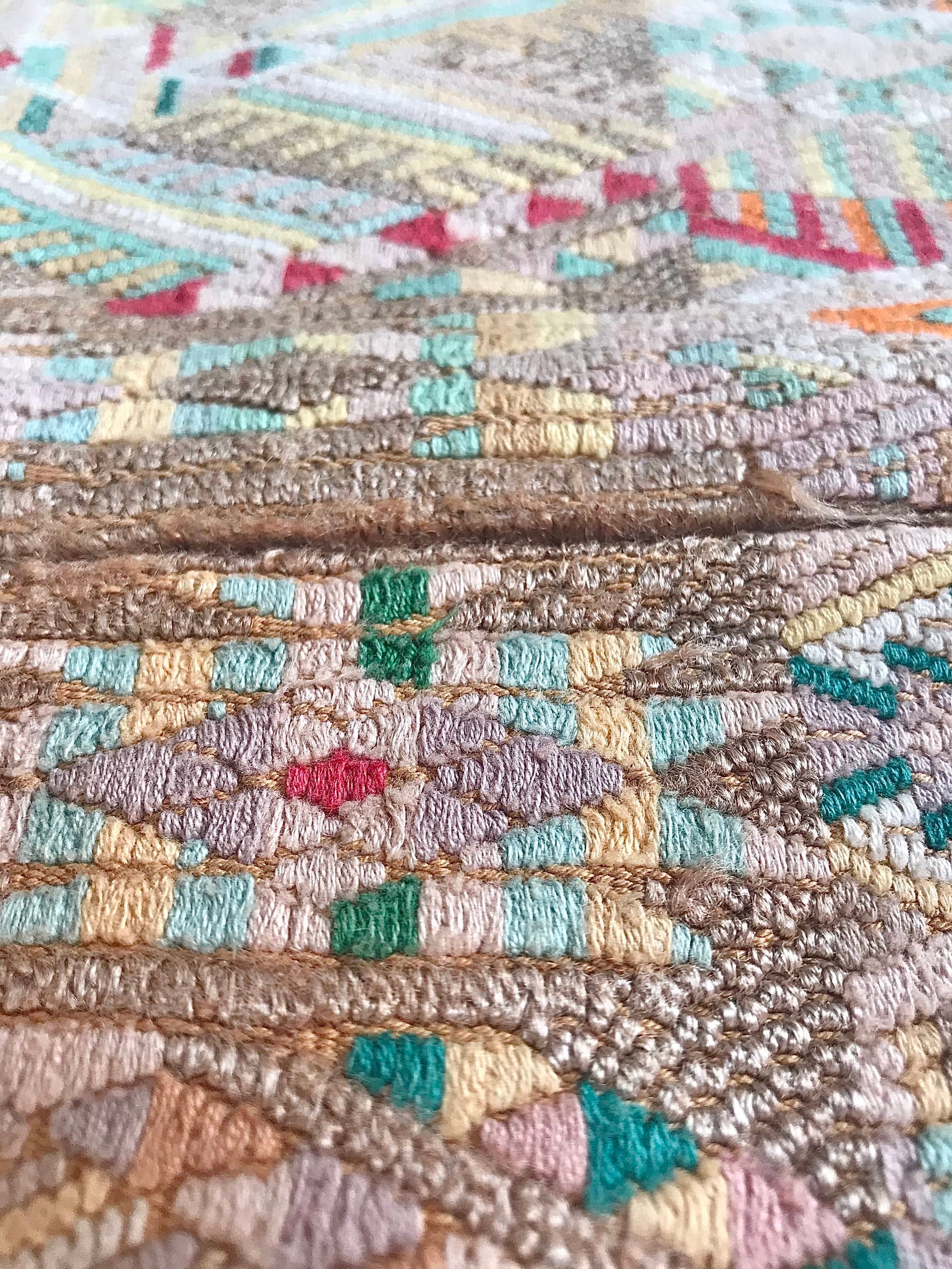 Guatemalan embroidered huipil pillow. Geometric chevron pattern in beige.