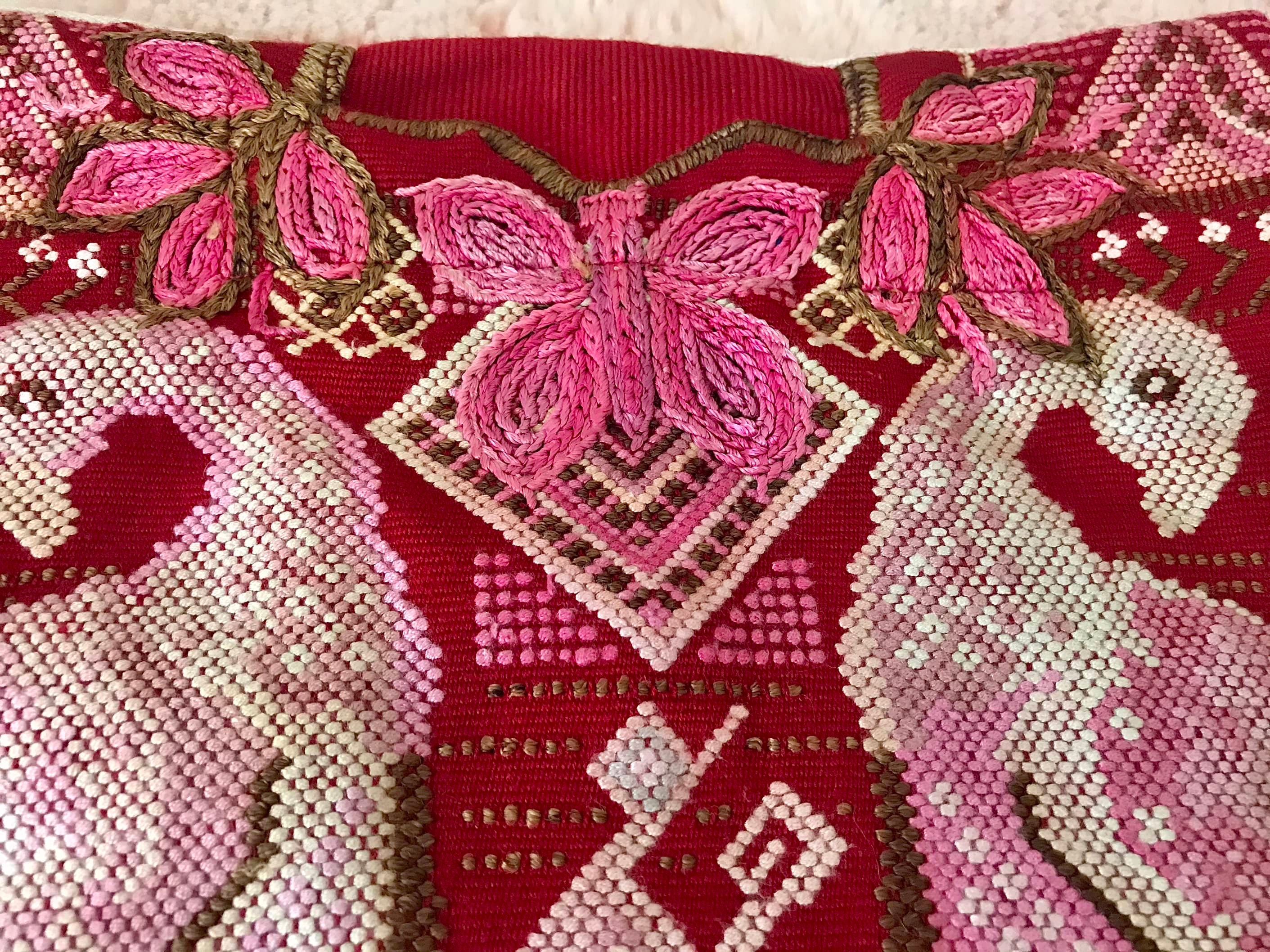 Guatemalan huipil pillow. A vintage textile with a red peacock bird design.