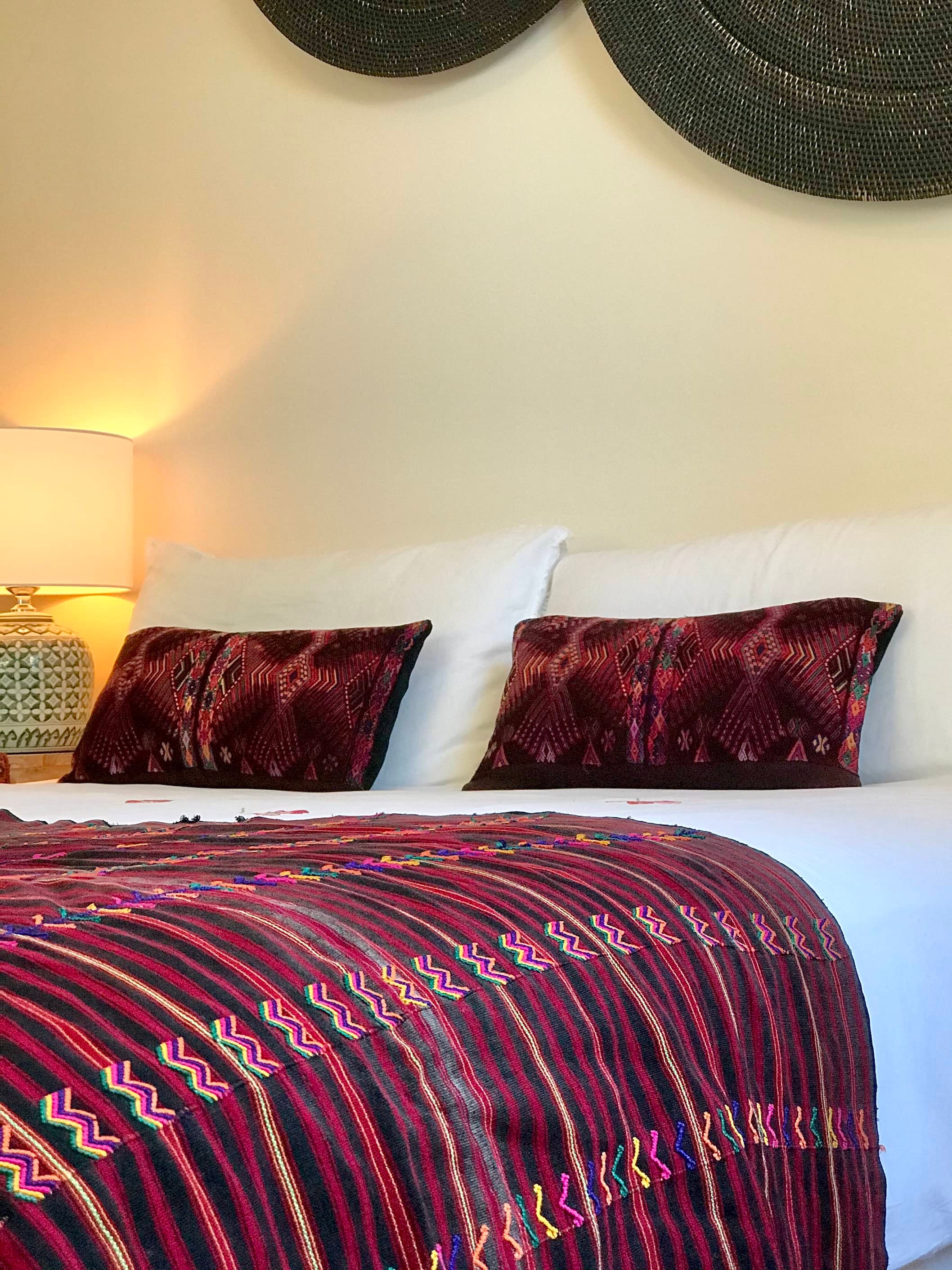 Guatemalan huipil pillow. A darkly exotic vintage textile with a stylised rising phoenix bird design.