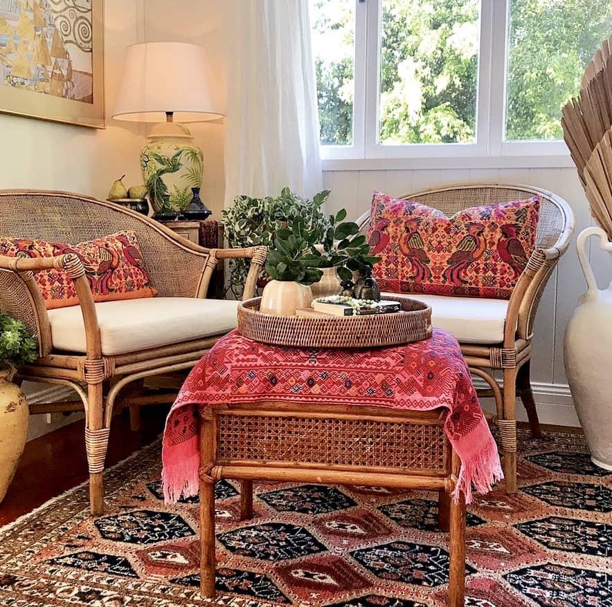 Guatemalan embroidered huipil pillow. Maximalist design of colourful parrots on orange cotton background