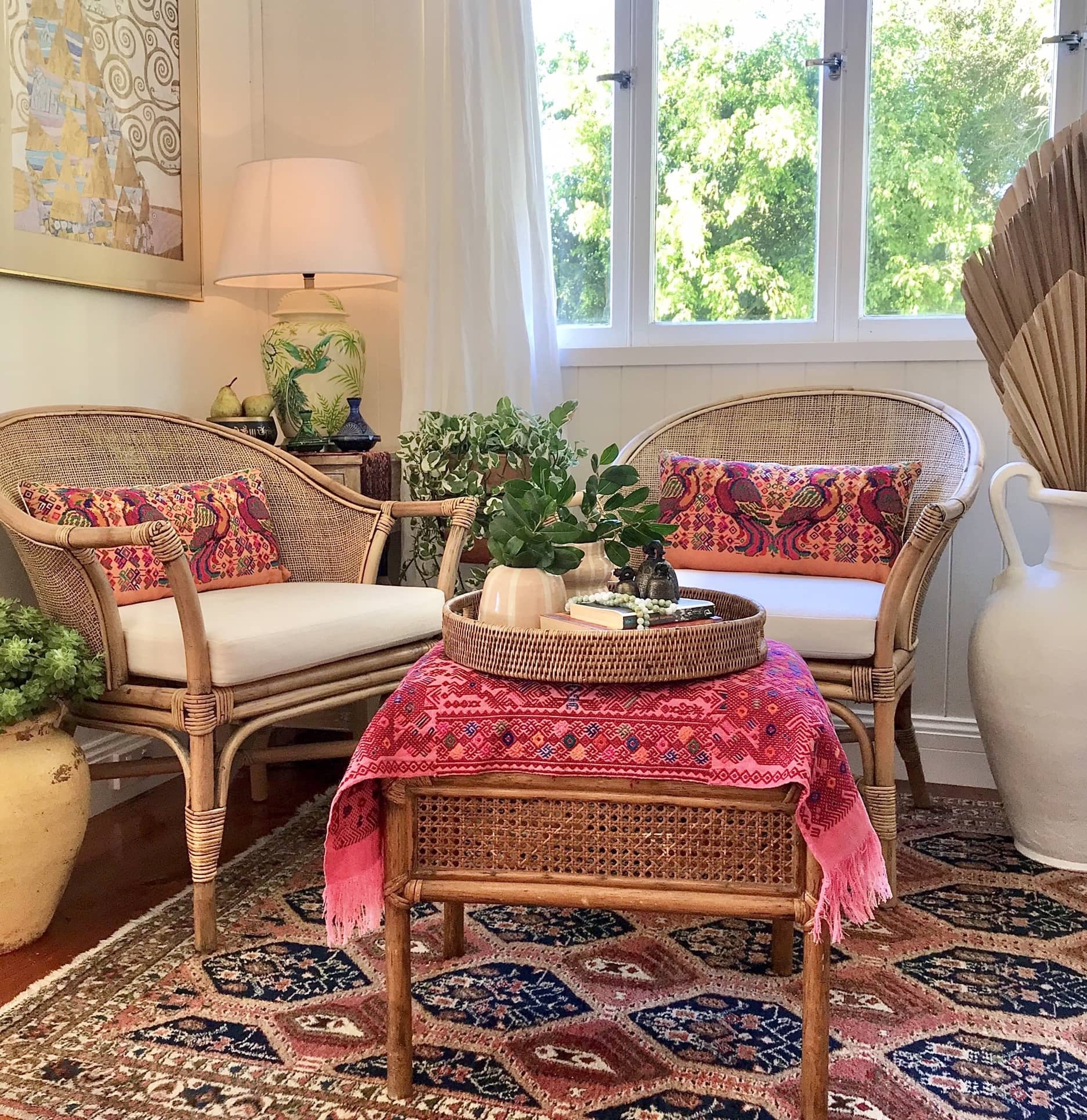 Guatemalan embroidered huipil pillow. Maximalist design of colourful parrots on orange cotton background