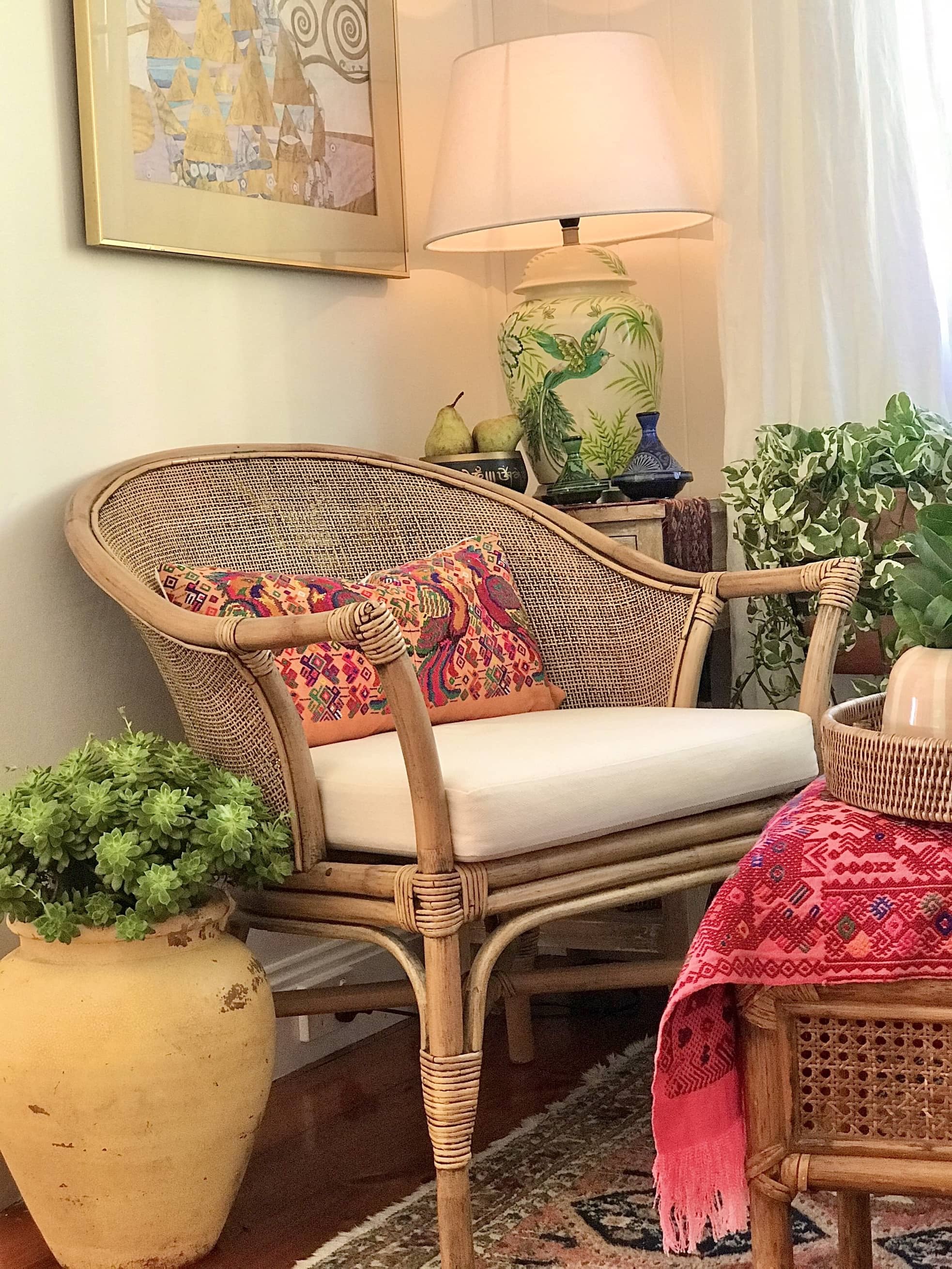 Guatemalan embroidered huipil pillow. Maximalist design of colourful parrots on orange cotton background