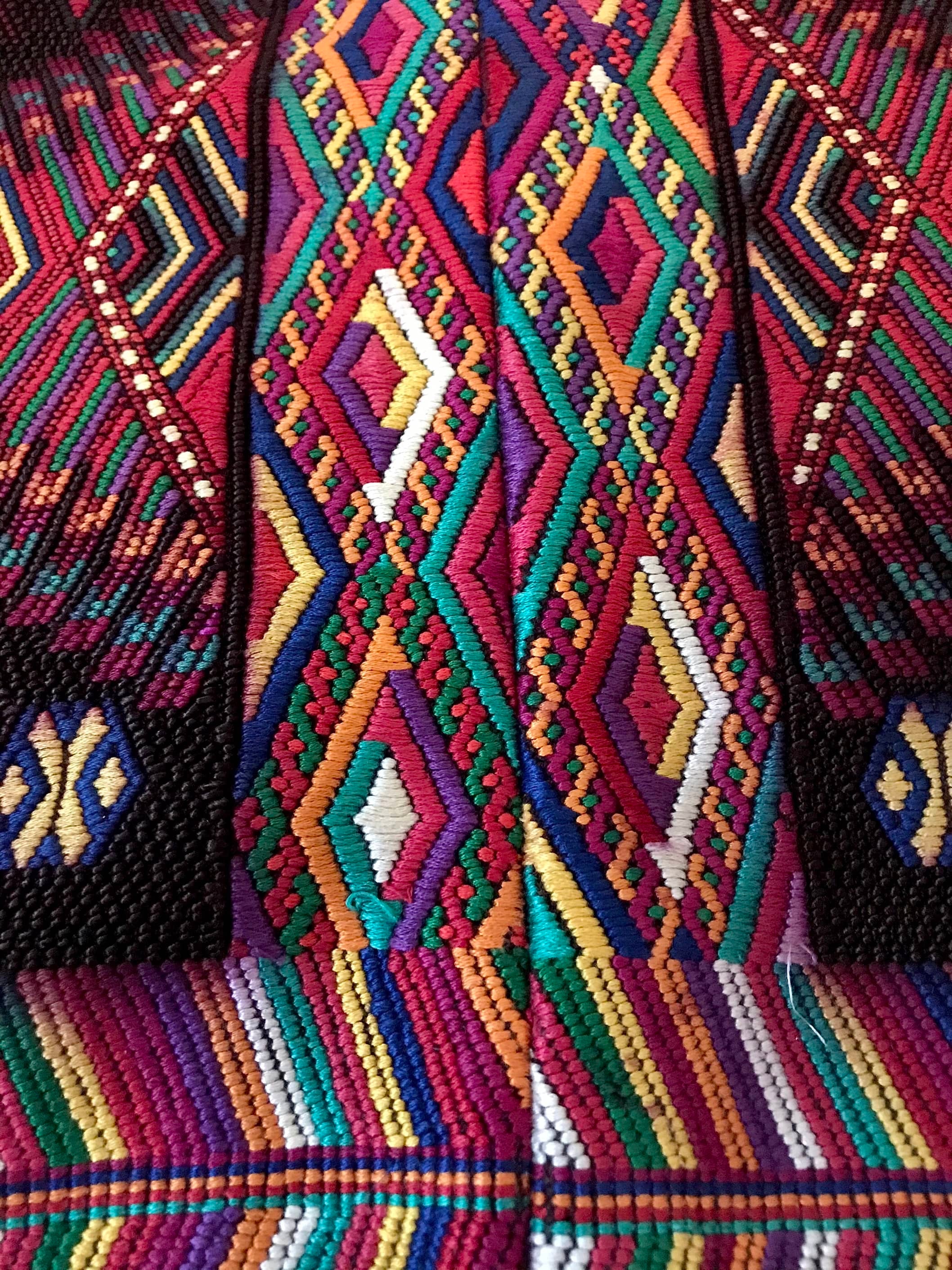 Guatemalan huipil pillow. A darkly exotic vintage textile with a stylised rising phoenix bird design.