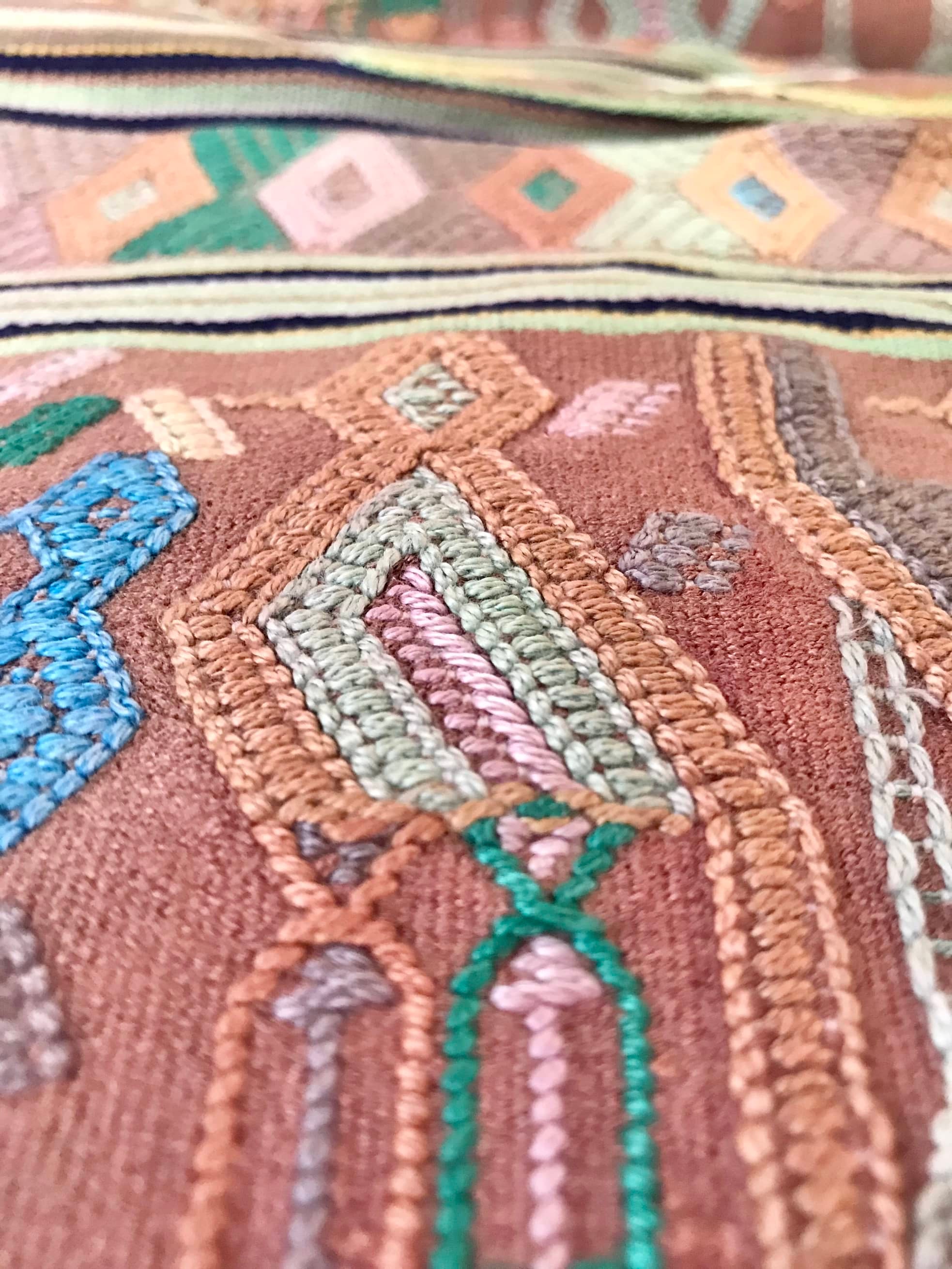 A Pair of Guatemalan Huipil Textile Pillows, vintage, hand embroidered striped tribal hieroglyphic design in aged coral