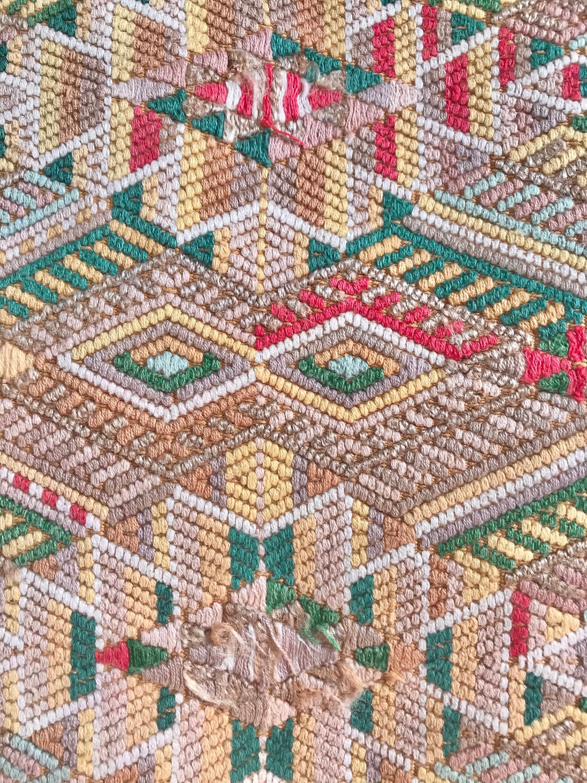 Guatemalan embroidered huipil pillow. Geometric chevron pattern in beige.