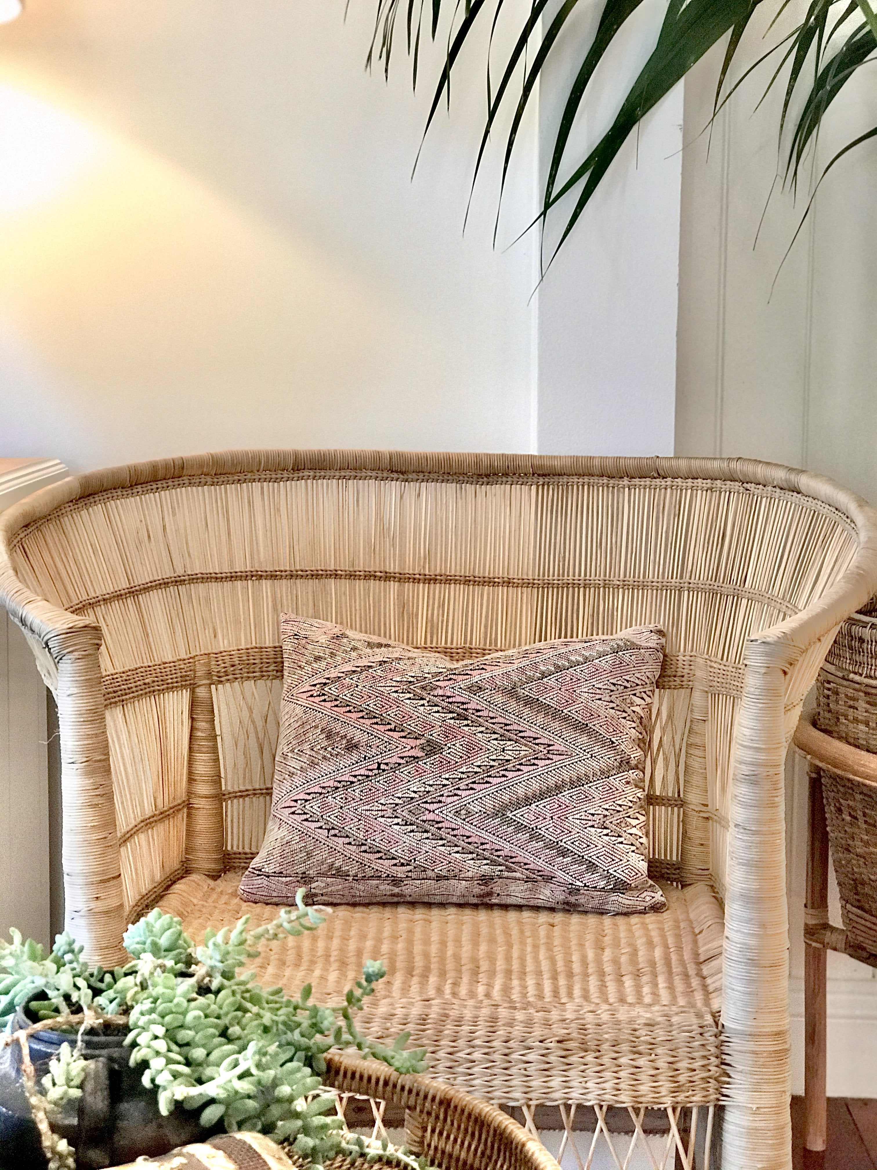 Guatemalan embroidered huipil pillow. Geometric chevron pattern in a pale pink palette.