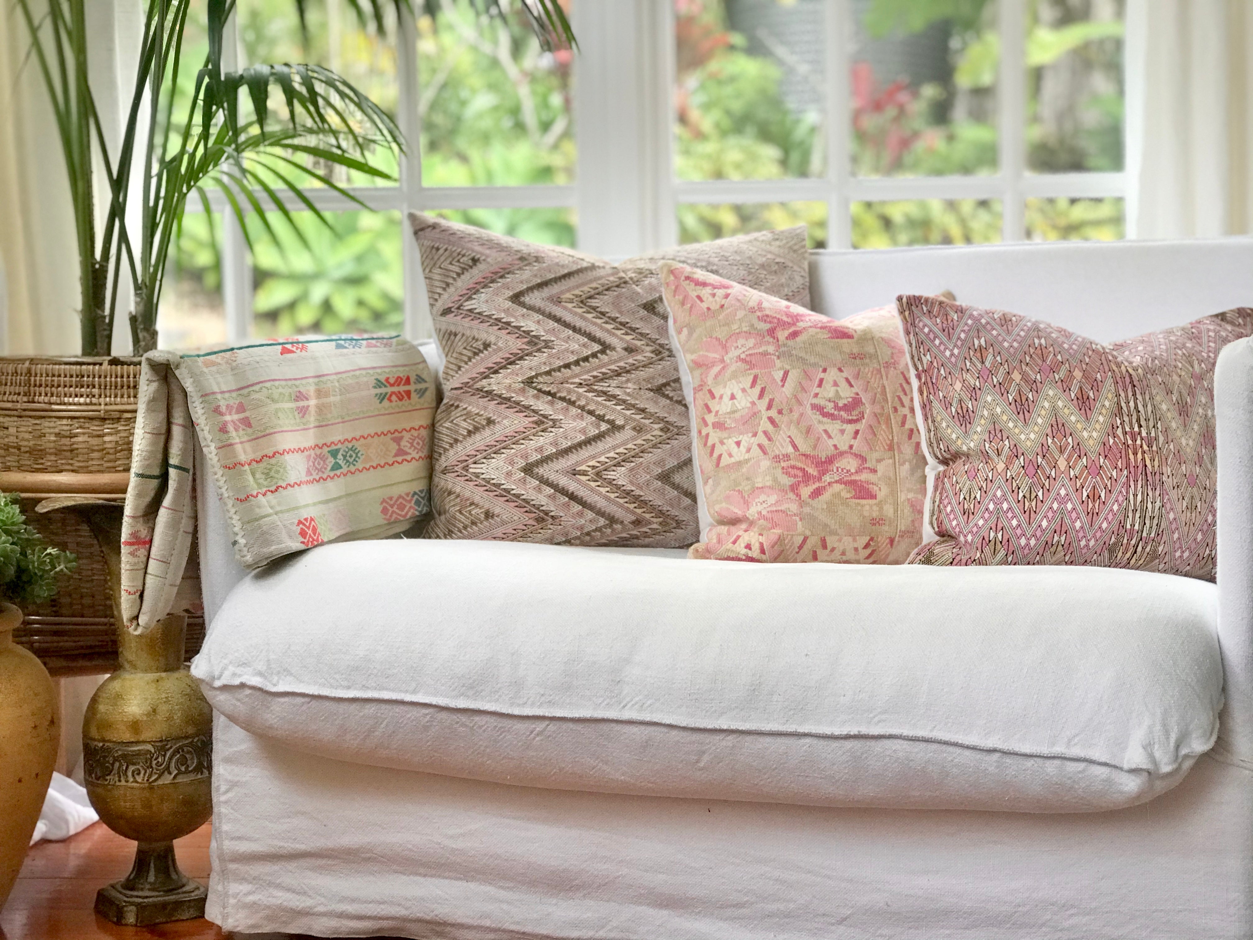 Guatemalan embroidered huipil pillow. Abstract flowers in a pale pink and white palette.
