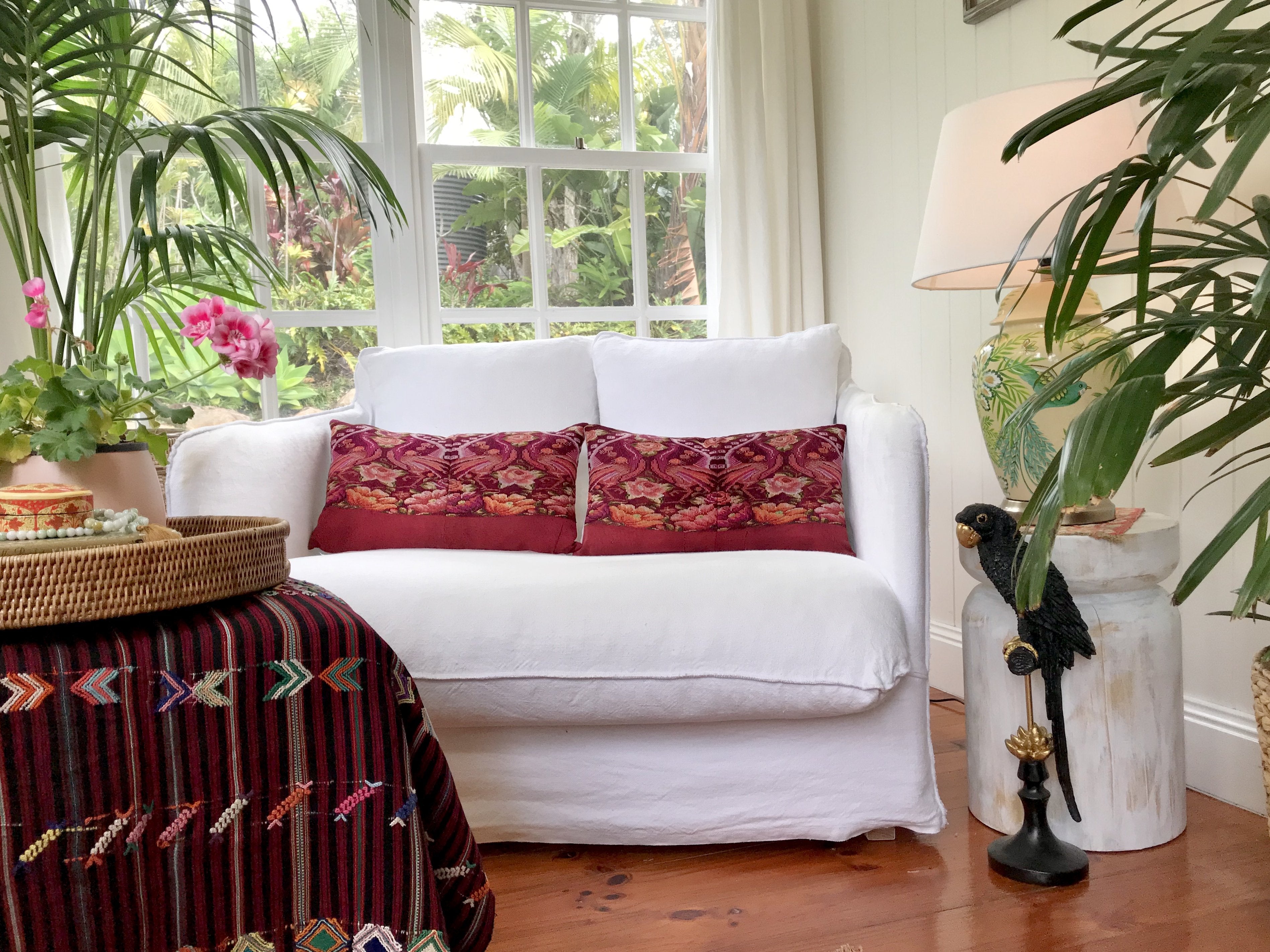 Guatemalan embroidered huipil pillow. Maximilist design of flowers and peacocks in rich burgundy.