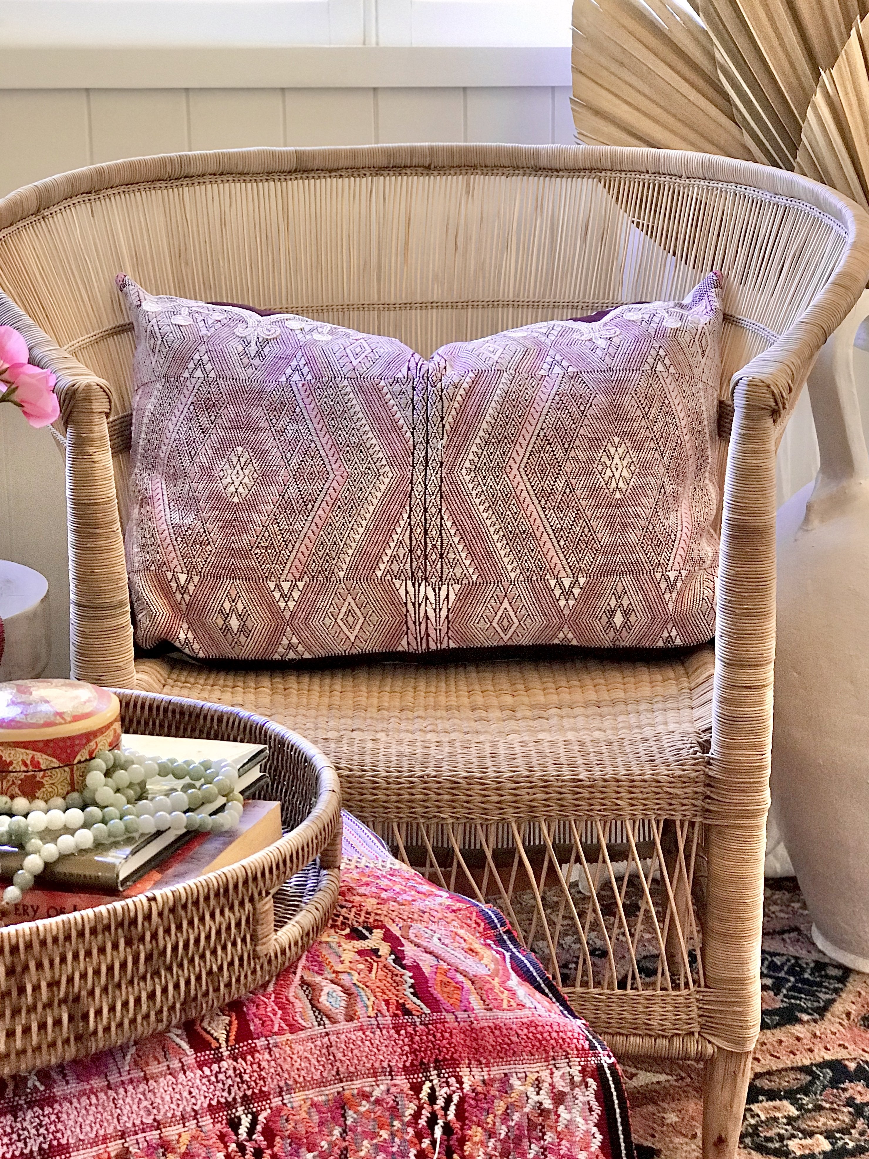 Guatemalan embroidered huipil pillow. Geometric chevron pattern in a pale pink palette.