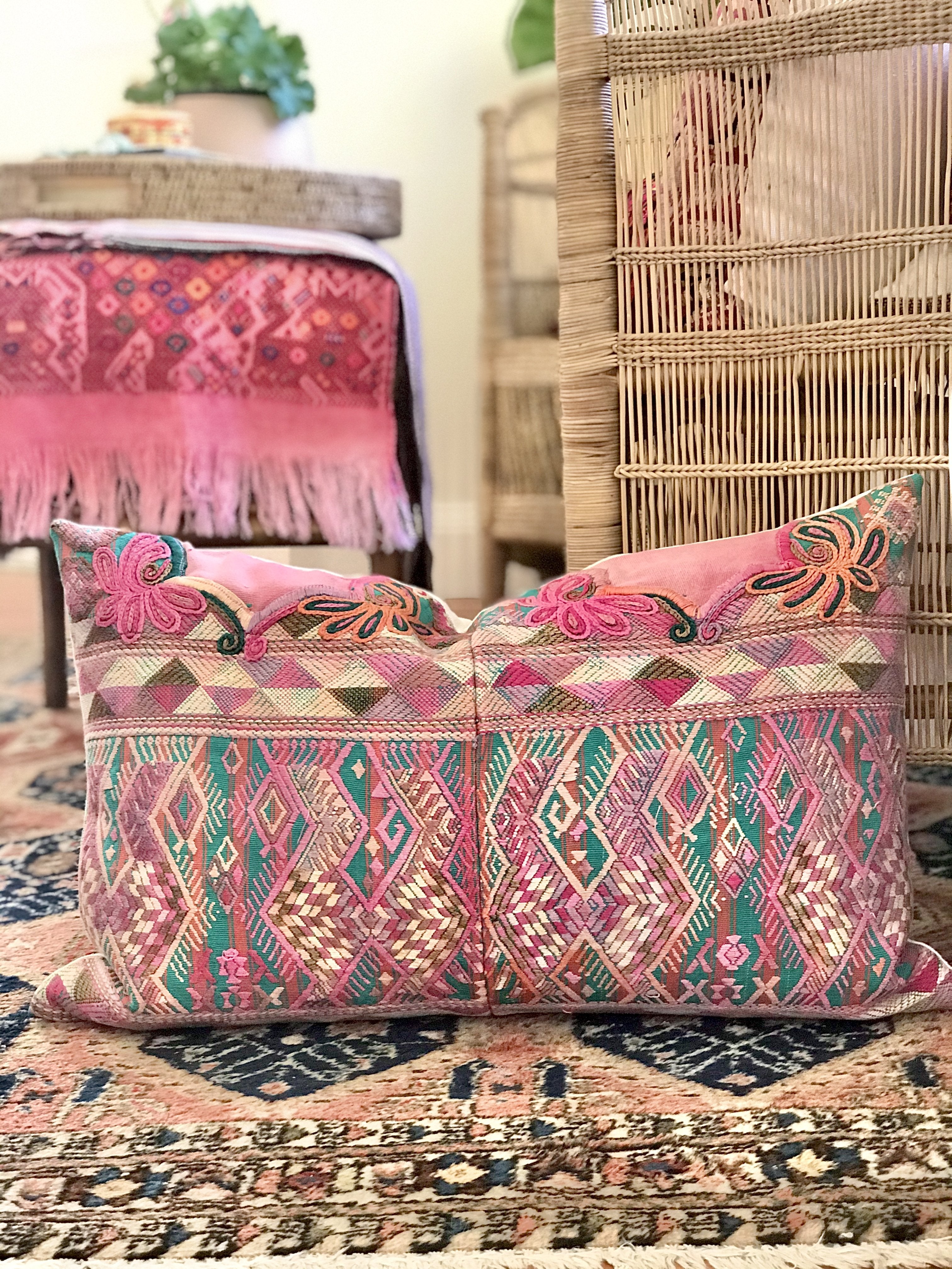Guatemalan embroidered huipil pillow. A pink and turquoise striped vintage textile with stylised horses.