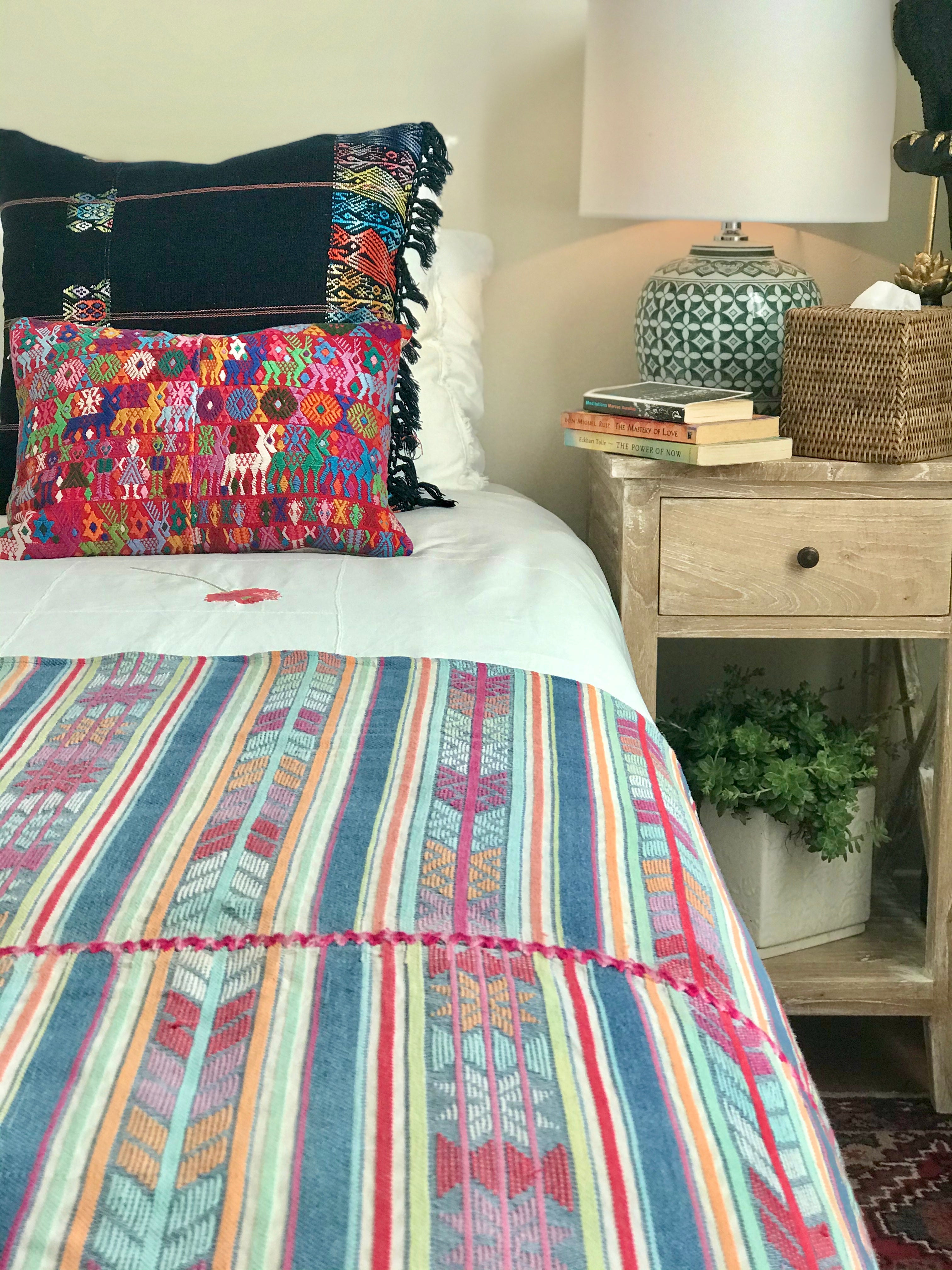 Guatemalan Huipil Pillow, vintage, hand embroidered Coban textile of brightly coloured tribal figures over a red cotton