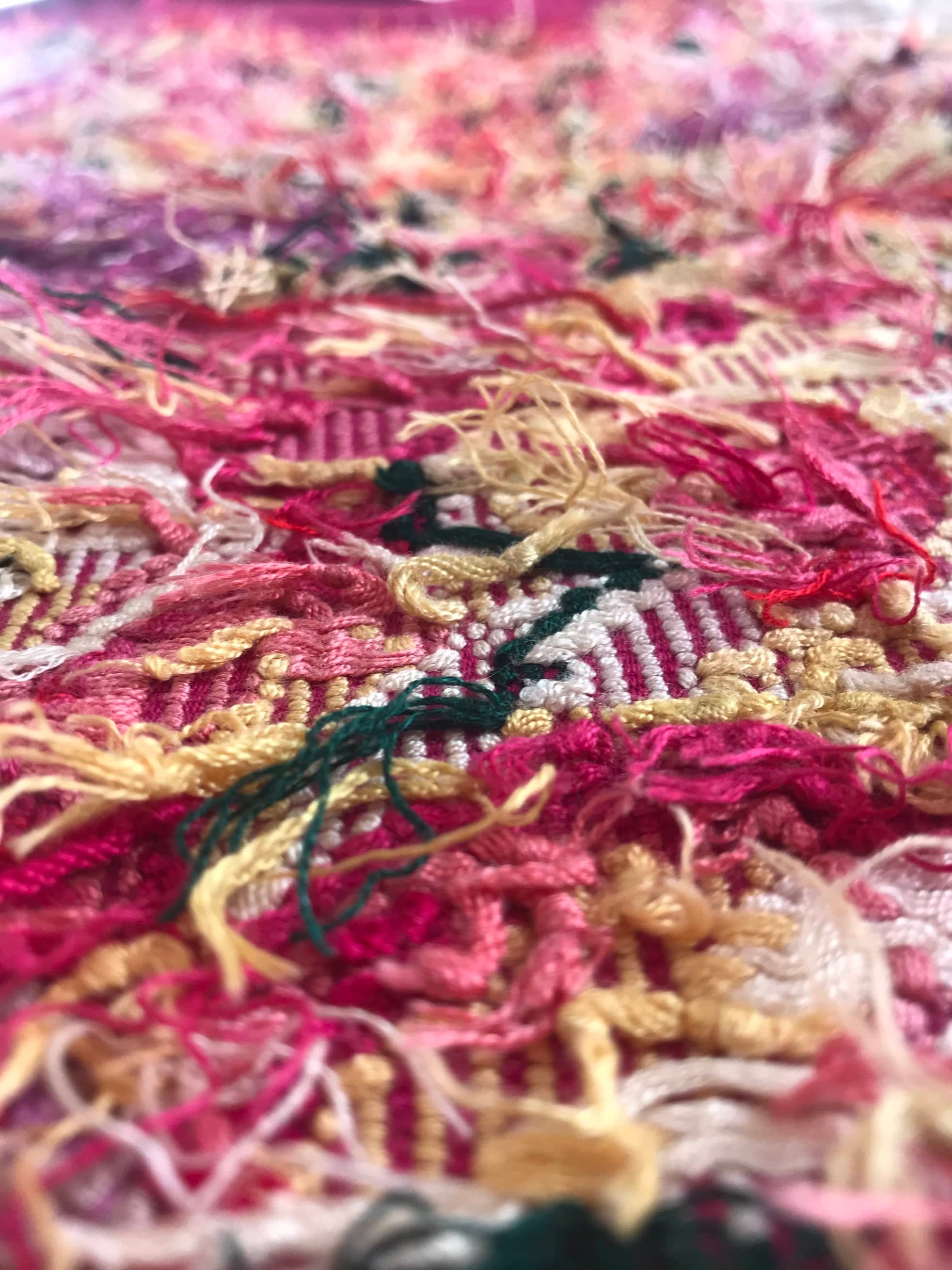 Guatemalan embroidered huipil pillow. A fuchsia vintage textile with an abstract floral design.