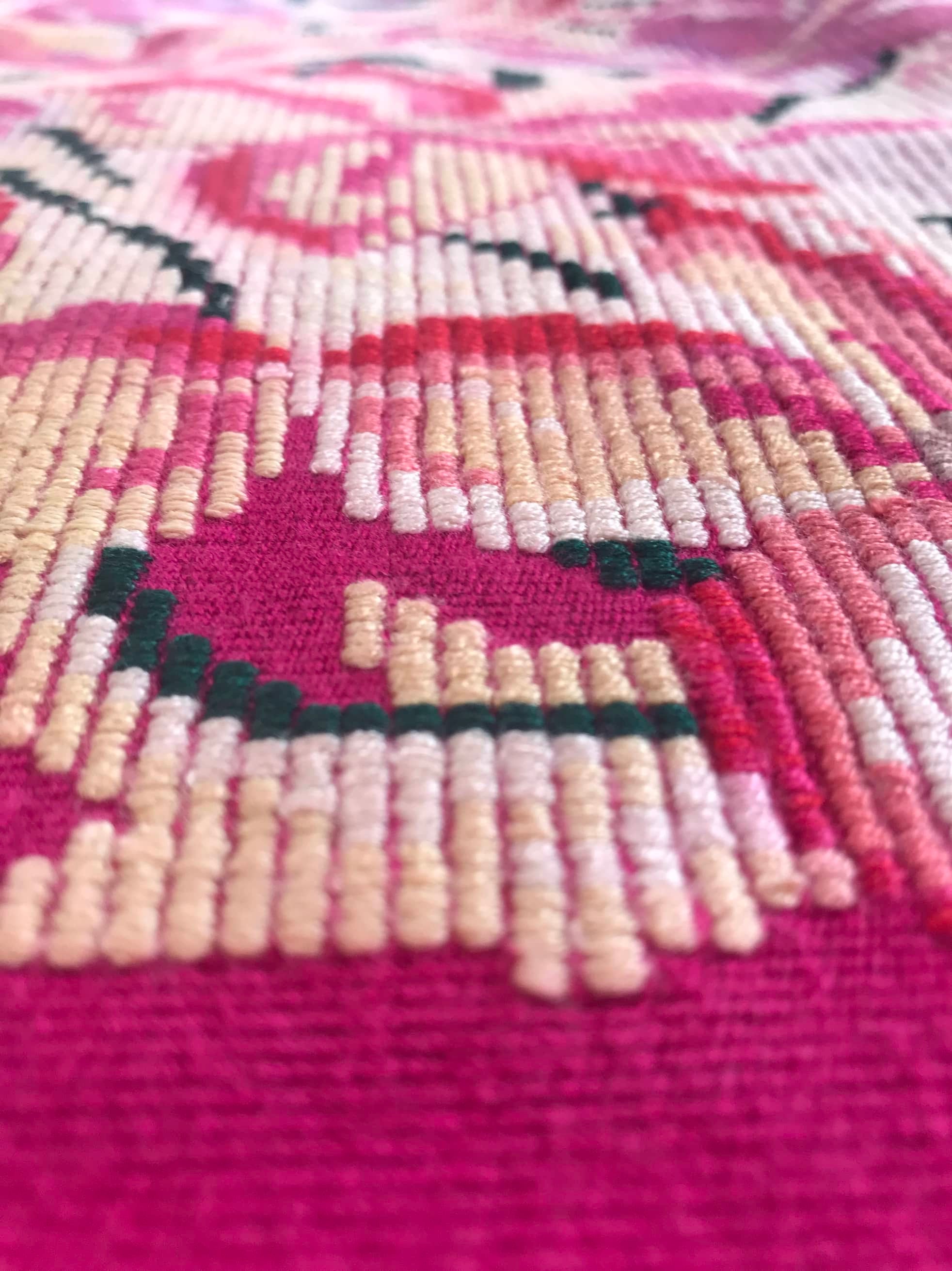 Guatemalan embroidered huipil pillow. A fuchsia vintage textile with an abstract floral design.