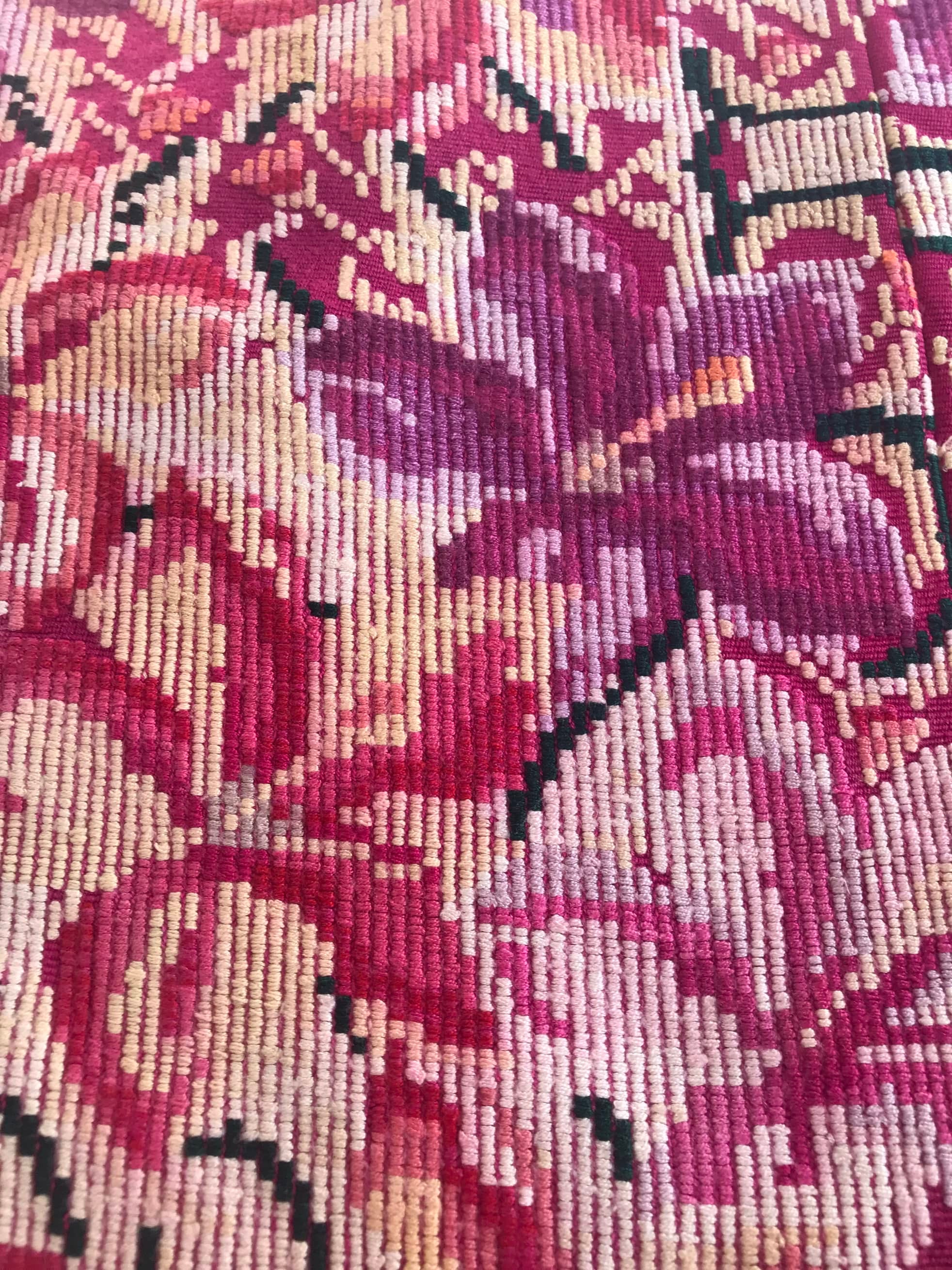 Guatemalan embroidered huipil pillow. A fuchsia vintage textile with an abstract floral design.