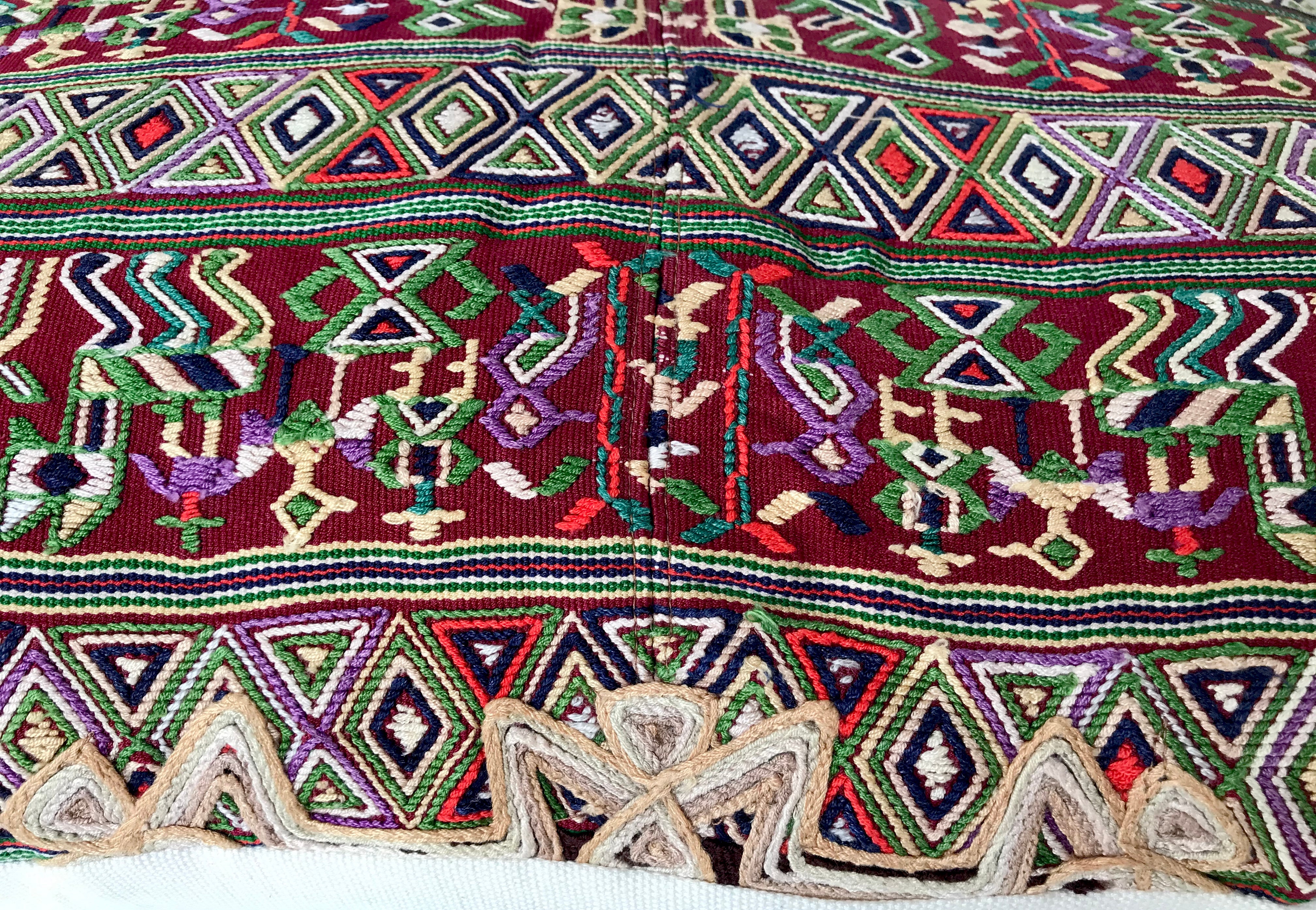 Guatemalan embroidered huipil pillow. a pair of pink and gold lumbar pillows in abstract design.