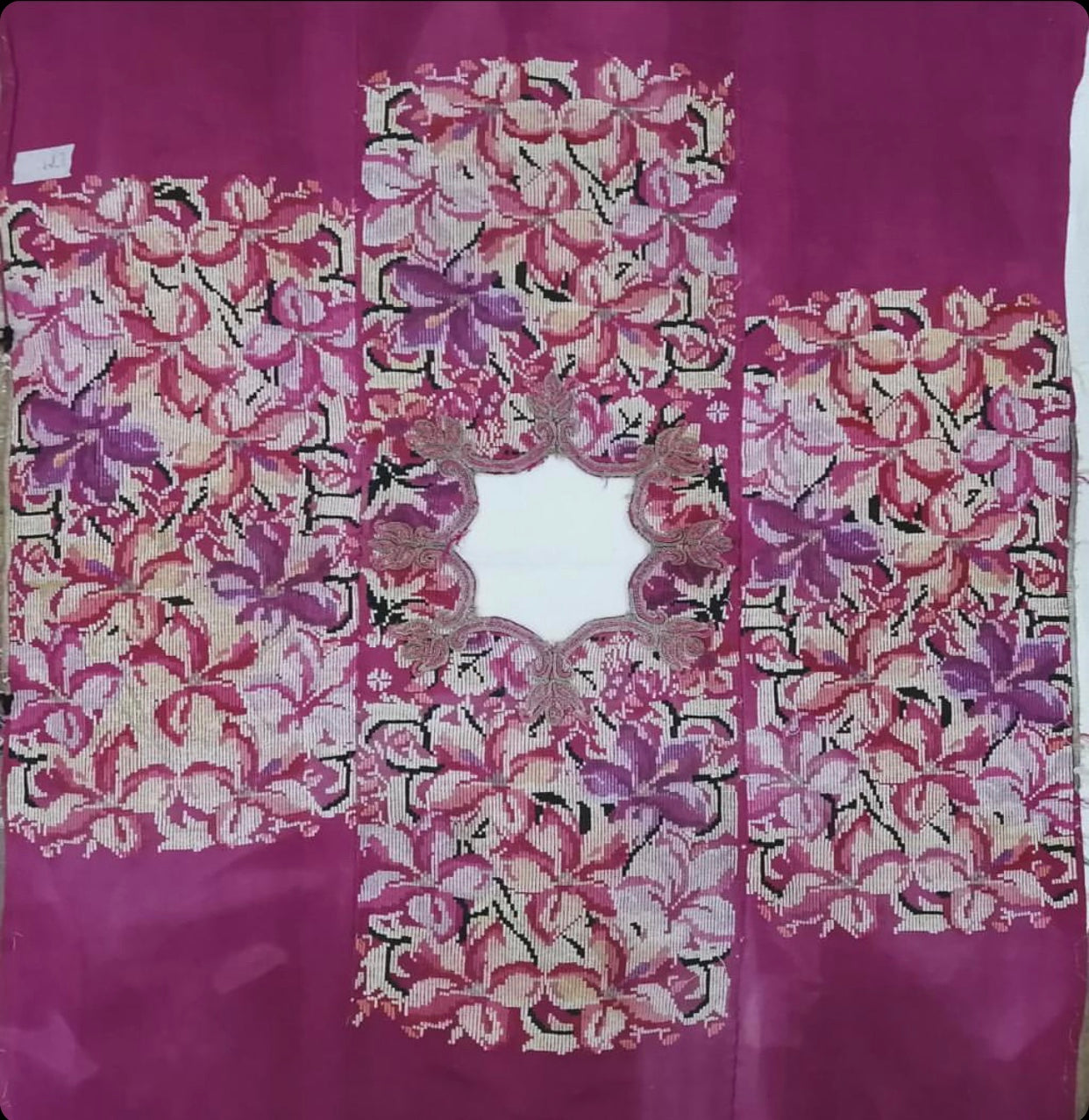 Guatemalan embroidered huipil pillow. A fuchsia vintage textile with an abstract floral design.