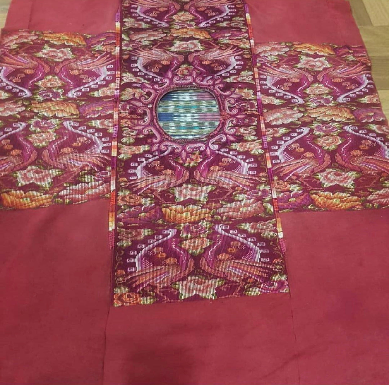 Guatemalan embroidered huipil pillow. Maximilist design of flowers and peacocks in rich burgundy.