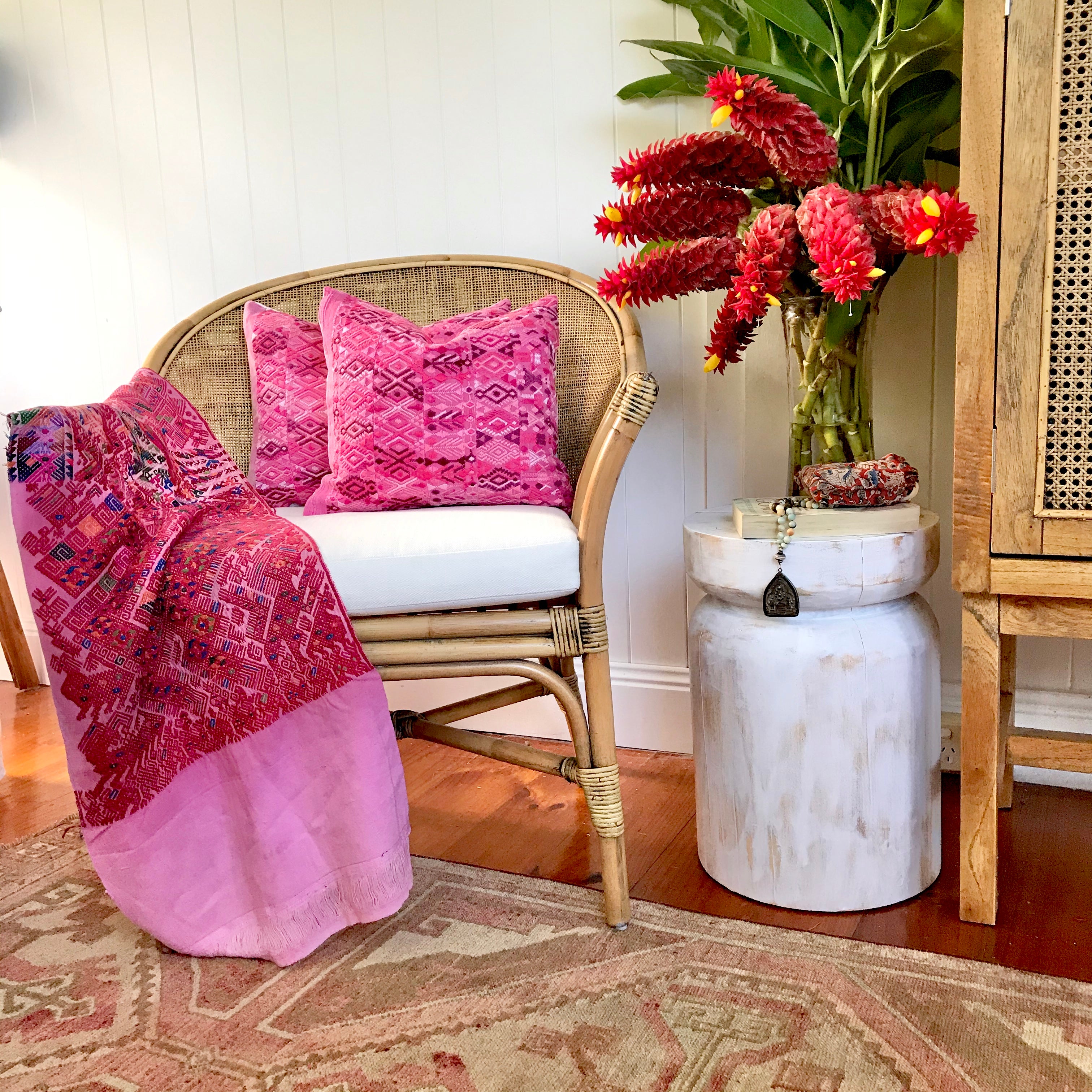 A pair of Guatemalan Huipil Pillows, vintage, hand embroidered textiles in bright pink with a playful tribal design