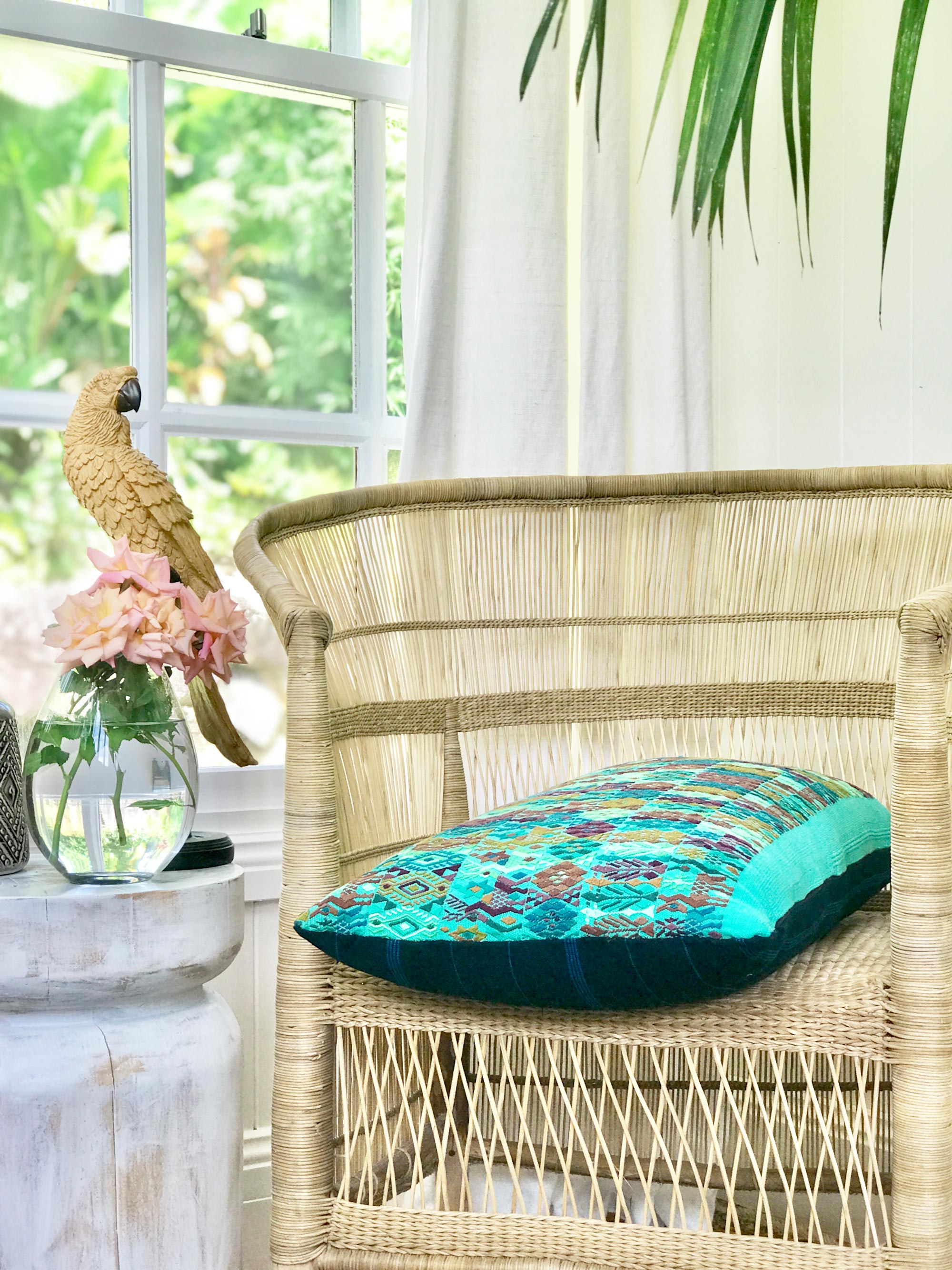 Embroidered textile cushions made from a Guatemalan huipil and corte.