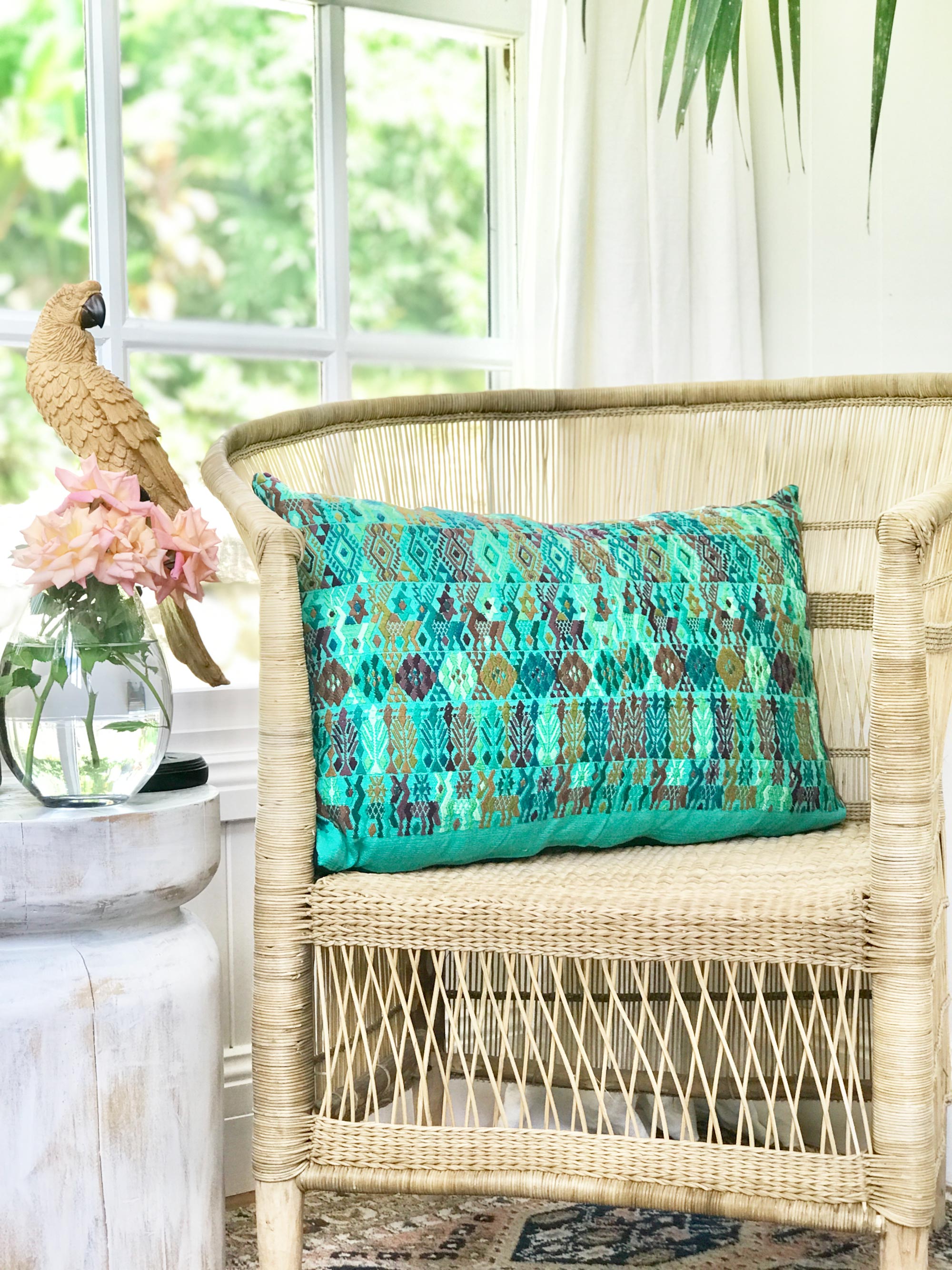 Embroidered textile cushions made from a Guatemalan huipil and corte.