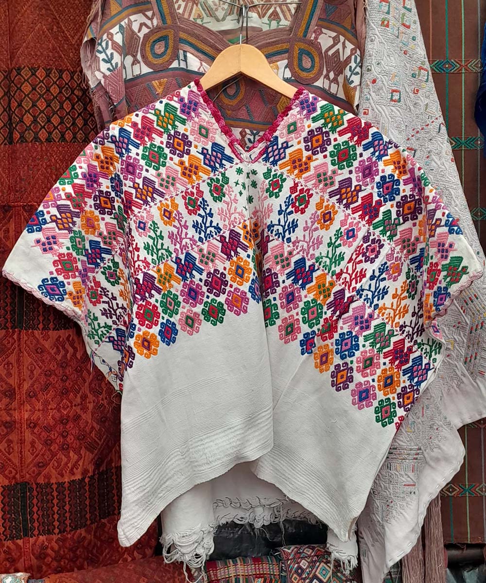 Colorful pattern on white huipil